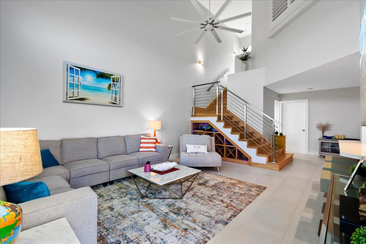 Not a single item was missed on this completely updated, fully furnished, turn key condo, directly across from the bright blue Atlantic ocean in the highly desirable community of Sea Colony! From a completely renovated kitchen and bathrooms, to ceramic tile flooring and a brand new custom hardwood staircase with stainless railings and a built in bar along with a wine cooler. All new Bosch stainless steel Kitchen appliances, custom soft close white shaker cabinets along with dove tailed soft close drawers. Custom lighting and fixtures throughout including new puck size recessed lighting and dimmer switches. The air conditioner is 2019 with a UV light installed to kill any bacteria for the air to be more pure. New water heater as well as new washer and dryer. New impact windows throughout along plantation shutters. Step out back to your own private balcony to watch the sunrise while drinking your morning cup of coffee! Upstairs you have a loft area with a small desk for someone working from home and a large master bedroom with stunning views of the bright blue Atlantic ocean! The master bedroom also includes a beautifully renovated master bath with dual sinks and a separate soaking tube from a large custom shower. Walk in master closet complete with custom built in shelves. This is the perfect modern beach home for any family! Large open floor plan with vaulted ceilings and large custom fans. Freshly painted garage with painted garage floor as well, stocked up with all your beach supplies! The community of Sea Colony not only offers your own gated pathway just steps from Jupiter beach, but a completely renovated, salt water community pool and spa, an updated fitness center and new pickle ball and tennis courts. Plus assessment has been paid in full! Just minutes away from 5 star resteraunts and shopping as well as the beautiful intercoastal and Jupiter Lighthouse!