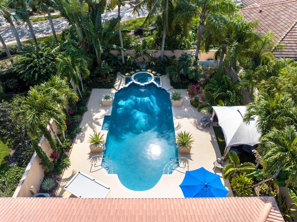 Masterfully designed 18x40 pool, raised spa & waterfall.  Back yard is lushly landscaped & professionally lighted that creates a resort-style oasis.  Pool is salt chlorinated & completely resurfaced.  Exceptionally long 70' driveway.  Whole-house accordion shutters & new hurricane garage door.  Plumbing redone with PEX piping .  Whole house water filtration ''halo system'' removes contaminates.  Remodeled bathrooms, laundry room, granite kitchen counters, Travertine marble floors  Large tank less water heater.  Office built-in cabinets, Custom Mahogany cabinets.  Sun dome for natural lighting in living rm. 4 miles to teal-blue Atlantic ocean waters, free parking on beach roads, dog friendly beaches,20 minutes to PBI airport, 10 minutes to Gardens mall,golf courses, A-rated schools
