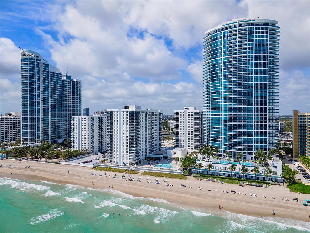 Oceanfront living at it's finest captured by this spectacular corner Aquarius residence with water views from every room!  Direct beach access! Open layout floor plan with glass to ceiling windows in main living room.  Walk out to wrap around balcony with intracoastal and stunning direct ocean views, overlooking both pools on property. Gorgeous Atlantic Ocean sunrises with matching opposite sunsets over downtown Hollywood's horizon. Eat in kitchen, washer & dryer in unit.  Main bathroom with separate soaking tub and glass encased shower. Building features two pools, upgraded gym with sauna, massage tables, and equipment.  Restaurant Acqua Bistro overlooks ocean and pool - Fantastic Italian food downstairs on site. Lobby with doorman, valet, game room, mail room, etc. Schedule a tour today!