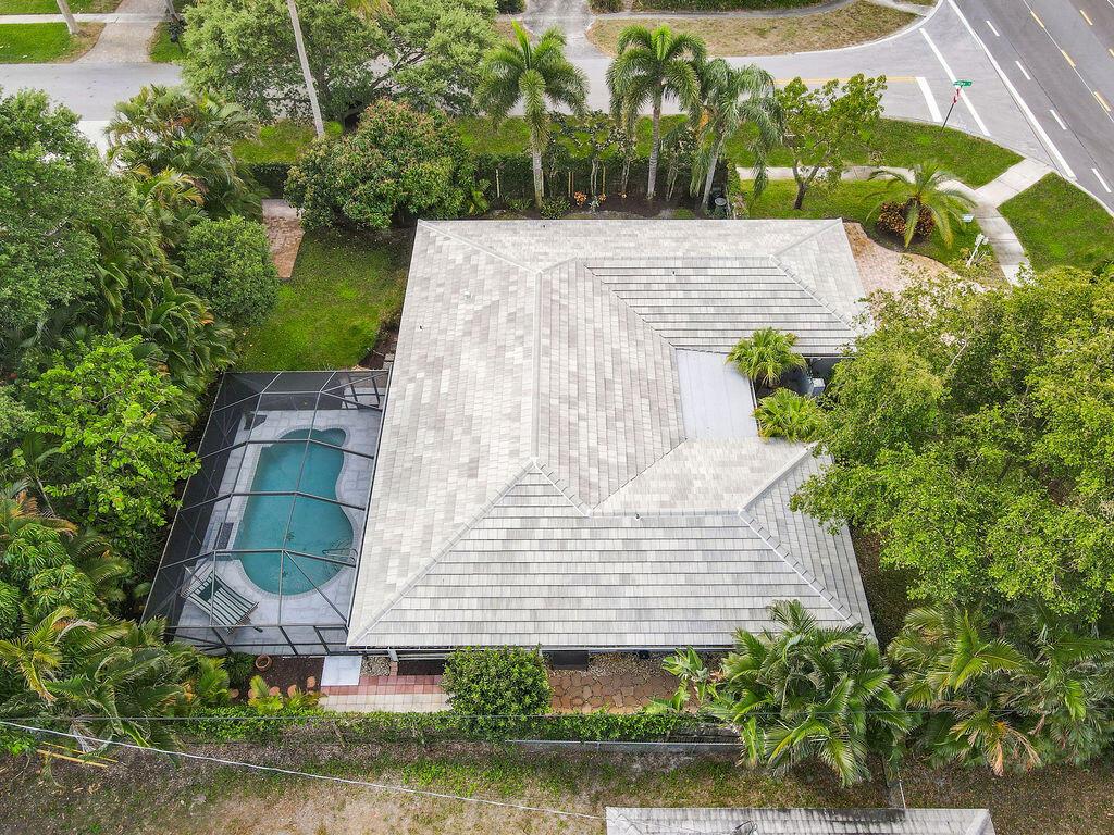 This is why everyone wants to move to Florida! Come enjoy your own oasis in the back yard with a cascading waterfall in the pool and a screened in deck created for parties or sunny lazy afternoons. Lucious greenery all around the house and fully fenced in back yard make it very private. Luscious greenery include trees like hass avocado, mango, banana, and palms. There is also a  pad with double gate doors for parking your boat or jet skis. Oversized corner lot, minutes away from beaches, restaurants and entertainment!EVEN MORE IMPORTANT: ROOF 2020, NEW PLUMBING, SALT water pool system w intermittent filtration, NEW waterheater!