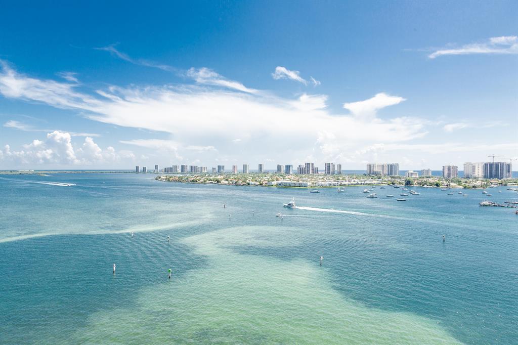 Million dollar views provide breath taking sunrises and amazing Intracoastal/Ocean views from this premier 15th floor Ocean Tower 2 bd/2 ba + den home. Custom features include: wood floors through-out (NO Carpet), cont. kitchen with SS appliances, new quartz counter tops, glass backsplash, new brushed nickel faucet, newer dishwasher & refrigerator & extra shelving added to the cabinets, contemporary LED lighting, ceiling fans & more! On-site dry storage marina for boats up to 50ft in a hurricane rated barn. Marina has day docks and fuel. Rent 1st yr ok with 30 day min & 3x per year. Storage cage provided. State of the art gym on amenities deck. Beautiful pool & jacuzzi. Pickup vehicles cannot exceed 18.5 ft in length. Assoc has assigned parking spaces for 2nd vehicle. This is a rare find!