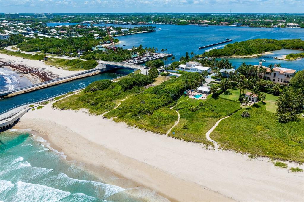 Rare Ocean-to-Lake property with 250+/- feet of lake frontage and 235+/- feet of ocean frontage. This expansive property is comprised of 3 parcels and features 3+/- acres to the water, private boat dock, and convenient access to the Boynton Beach Inlet. Fantastic opportunity to build new on one of the largest oceanfront parcels in Manalapan. This unique property currently offers two existing homes that you can live in while you design your oceanfront dream home or compound. The possibilities are endless!