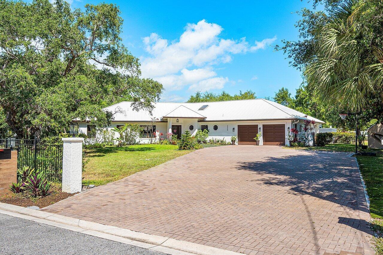 Introducing a true one of a kind GEM in East Palm Beach Gardens! This stunning property is located just steps from the intracoastal and mere minutes from the beach. This nearly 2-acre compound stretches from Seven Oaks LN to Laurel LN, offering you the peace and serenity of your own private oasis or endless opportunities for builder spec homes!As you enter the gated entrance of this luxurious property, you will immediately feel the exclusivity and privacy it offers. The 5 bedroom (4 + Plus Den) one-story CBS home was built in 2011 and sits on over 1.5 acres of land in the heart of Palm Beach Gardens, off Prosperity Farms Rd! 
Completely redesigned and professionally remodeled with the highest quality of finishes, this home is truly a masterpiece. Some features of this breathtaking property include an open/split floor plan, cathedral ceilings, impact glass windows and doors, generator, paver patio, custom kitchen, new floors, chef's kitchen, custom RJS built home, extra deep garage, no HOA, and low county taxes.

The master bedroom is the perfect retreat after a long day. The bedroom is spacious and includes an office, making it the perfect spot to work from home or simply unwind after a busy day. The other 4 bedrooms are equally luxurious, ensuring that everyone has their own private space.

Whether you are a developer looking to build your dream home or a family searching for your own private paradise, this property has everything you could ever need. With its prime location, luxurious finishes, and endless possibilities, 2460 Seven Oaks Lane is truly a once in a lifetime opportunity that cannot be missed!