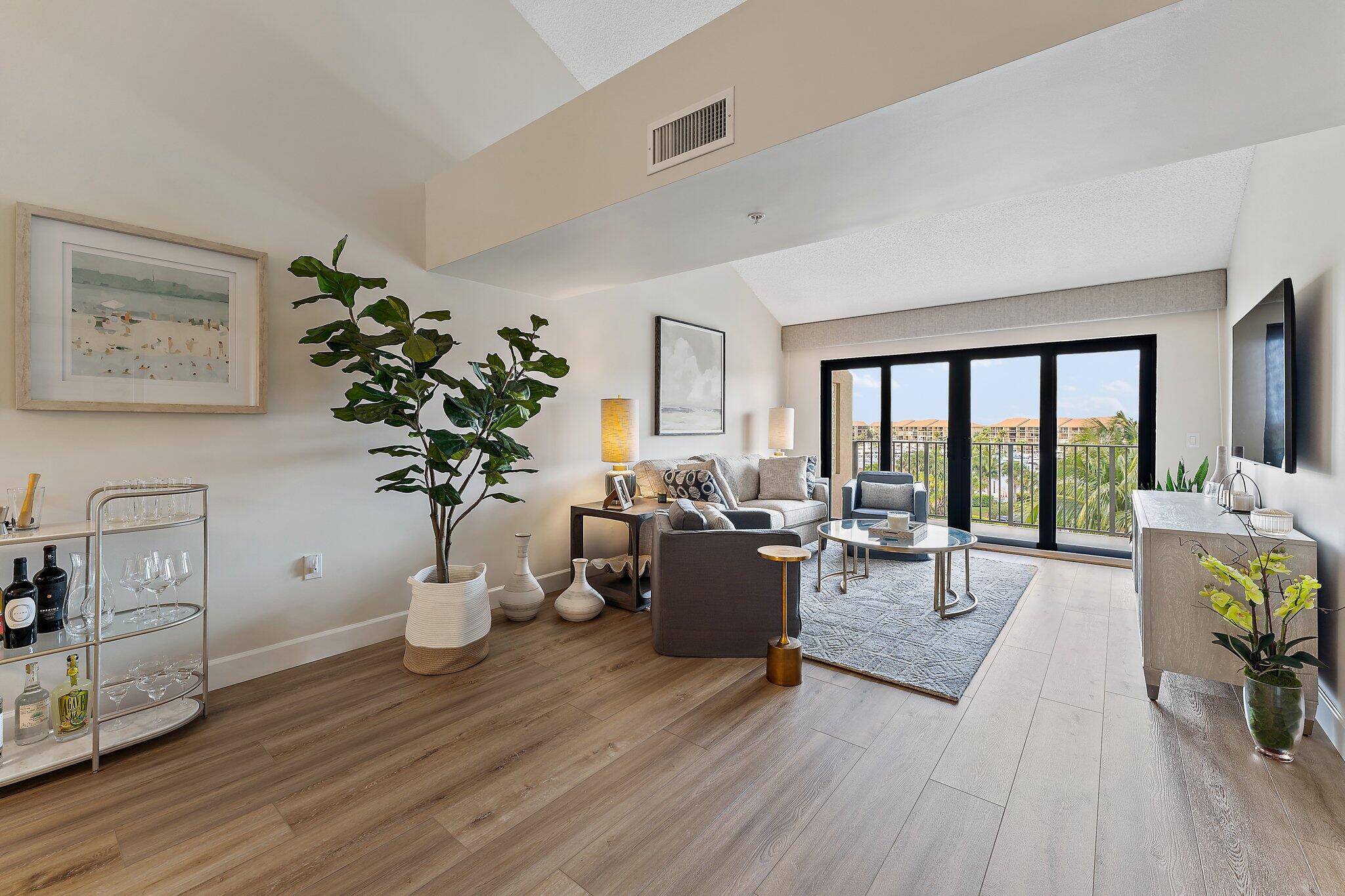 Welcome to this stunning, top-floor residence at Marina at The Bluffs. This warm and inviting condo was just extensively renovated with top-quality finishes including luxury vinyl plank floors, new lighting and electrical throughout, quartz countertops, and upgraded trim & hardware. Featuring soaring vaulted ceilings, available in only a select few units, this home is flooded with light and a sense of openness. Enjoy an expansive view of the marina from the spacious balcony or through the hurricane-rated impact-glass windows and sliders. Beautiful, brand new high-end furnishings from top-brands such as Lexington, Vanguard, Basset, David Francis, and more are available for purchase and perfectly suite this incredible space.