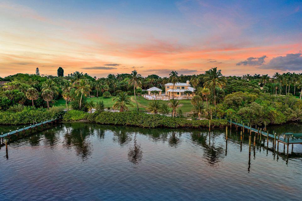 The possibilities are endless with this Jupiter Island home sitting on 1.5 acres of land and approximately 146 feet of deep-water Intracoastal frontage with an expansive dock and extraordinary deep blue water views.  The residence currently features 4 Bedrooms, 6 Baths, a 2 Story foyer, and optional spaces to enjoy the ocean breezes. Situated in the premier location of Jupiter Island; this property encompasses the perfect combination of proximity to shops and restaurants, yet secluded enough for serenity and privacy.