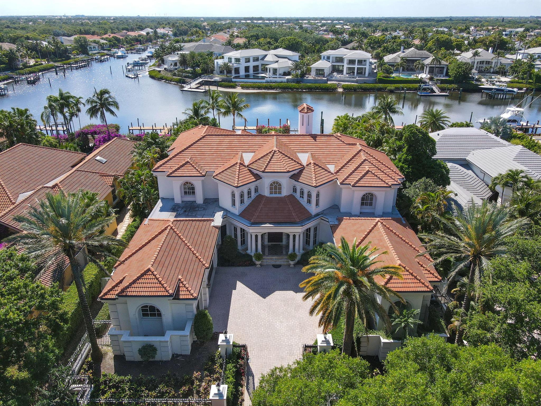 Outstanding custom estate located in the exclusive guard gated community of Admirals Cove. Sits on 110'  of water frontage with no fixed bridges. This timeless masterpiece features 5 BR/5.1BA + office, 9,101 Sg Ft soaring ceilings and spectacular water views from almost every room. Luxurious master suite with large sitting room, his & hers baths and walk-in closets. Gourmet kitchen. Step outside to be greeted by a  resort styled back yard with large pool & spa, lush landscaping. Brand new summer kitchen makes it perfect for entertaining and enjoying the beautiful sunsets and tranquil water views.FURNITURE INCLUDED.  Amenities: 45 holes of golf, 5 restaurants, 58 slip marina with floating docks, Yacht Club, Har Tru tennis courts, pickelball courts, and state of the art gym.