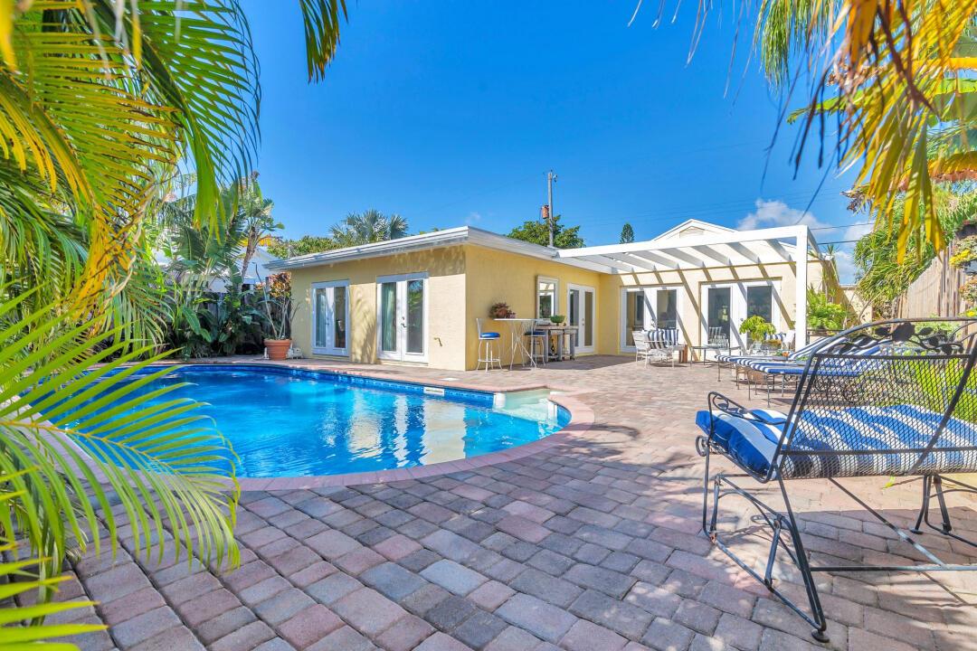 This beautiful, serene home becomes your retreat from the rest of the world, with lots of sunlight and an oversized pool where you can just relax the day away. The home is only minutes from downtown.Lake Worth's vibrant nightlife and paddle boarding is close to your front door. Each bedroom has its own bathroom and own poolside door access to the pool area. With an open concept floorplan, it is a perfect place to entertain, especially with its large, gourmet kitchen, complete with two wall ovens, one full range, three refrigerators, and plenty of cabinet storage.There are impact doors and windows throughout the home. The beautiful kitchen has 2 wall ovens and 1 full range three refrigerator's plenty of storage and laundry area has stacking w/d this would make a great air b &amp; b or seasonal rental. This neighborhood is located east of federal north Lake Worth Beach sets next to collage park area and only two block from enter coastal. There are three patio areas to lounge and escape the hustle and bustle of todays new normal. Your very own retreat is waiting for you.
