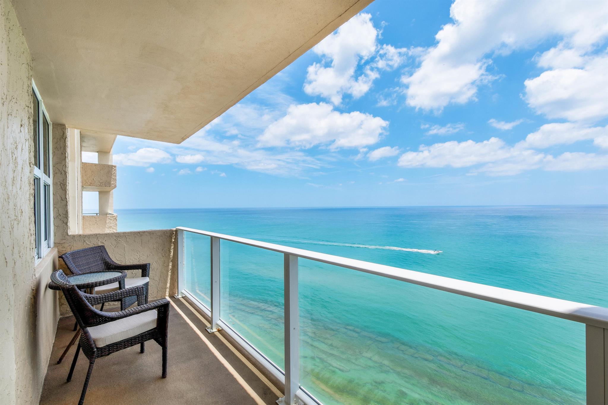 Beautiful Southeast corner unit with wrap-around balcony. Exceptional ocean and intracoastal views form all rooms. Updated kitchen with oak cabinets and level 5 granite breakfast bar and counters. Open floorplan with views of the crystal-clear water. Balcony has clear tempered glass railings and unit has full hurricane impact windows and slider. New wood-like tile floors and beautiful driftwood tile accent wall in the dining room. Large windows bring the outside in and the view of the water is like watching an aquarium seeing many fish, manatee, dolphin, turtles, sting rays and so much more swim by, Great snorkeling in front of building with reef right off the beach.Pet-friendly, 1, 15 pound pet. Read a book, sunbath or just relax as you enjoy the ocean breeze. Unit has light paint and new Hunter Douglas pleated shades. Wet bar is great for entertaining and unit has own stackable laundry. Master suite is huge and has an enormous walk-in closet, black-out blinds and great ocean and city views from triple window. Master bath has new vanity with granite counters and private toilet area. Guest bedroom has a large full-wall closet. Guest bath has new vanity with granite counter, wainscoting and bathtub to relax after a long day at the beach. unit has storage cage on the floor and there is bike/golf storage on the floor too. Complex just went through concrete restoration. Building has exercise room, sauna, billiard room, community room with kitchen, library, large laundry on each floor and in unit, barbeque area with two built-in gas grills, a large dining table right on the ocean. Community pool and sundeck is a great place to enjoy the Florida outdoor lifestyle. A short walk to MacArthur State Park where you can kayak and take advantage of the nature trails and shows. Bike 2 miles to the Ocean Mall on the sidewalk with overhead lights which meanders along the intracoastal. Great Singer island location, close to tons of shops and restaurants, three International airports, enjoy cultural events at the Kravis Center, Maltz Theatre, and Coral Sky amphitheater. Don't miss the chance to live in paradise in a renovated building on the north end of the island.
Limit 1 pet, 15 lbs max. Rentals permitted in 1st yr of ownership.