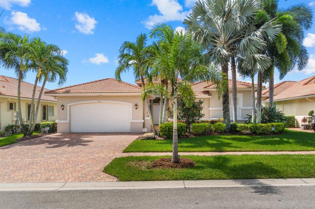 A Home to Match Your Successful Lifestyle. Nestled in the highly sought-after Tivoli Lakes neighborhood in Boynton Beach, this is one of the largest floor plans in the Estate Collection, ''The Cabernet''. This Mediterranean inspired Ranch offers an exceptional opportunity for those seeking an Open & Spacious, Beautiful and convenient place to call home. Situated on a Captivating Lakefront lot and offering Panoramic Views, from the Kitchen, Breakfast Nook, Living room & the Main Bedroom Suite. Upon Arrival you can't help but notice the 12-14 Ft Tray Ceilings and the Natural Light, enhancing the warm and inviting atmosphere.  This house offers ample living space and a thoughtfully designed floor plan. The main living areas of the home provide a seamless flow, perfect for both relaxation and