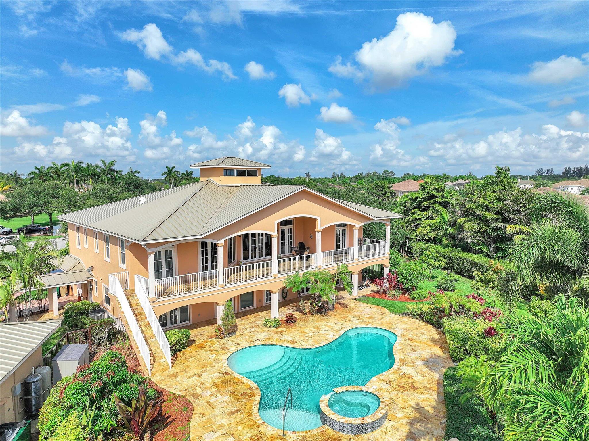 Active, back on the market. Contract was not funded.  Magnificent custom built two story home on 0.96 acre on quite exclusive cul-de-sac road featuring a marvelous salt water heated pool with spa, gazebo with bathroom with heated showers, steam room, sauna, and BBQ area.  Impact doors and windows. Two laundry rooms, easily converted to 7 bedrooms, 4 AC units (split). No homeowner's association, no restrictions, abundant tropical fruit trees, and beautiful landscaping. Five zones sprinklers system, alarm,  security cameras and diesel backup generator.  Well maintain home. Don't miss this opportunity to live in paradise 20 minutes drive to Hard Rook Hotel & Casino and Ft Lauderdale beaches!