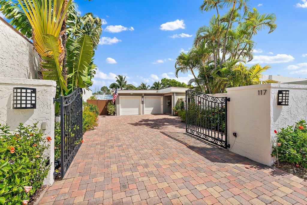 Located in a tucked away cul-de-sac on one of the largest lots in the gated community of Ocean Walk, this 3 bedroom, 3 full bath pool home even comes with its own security gate.  Enjoy vaulted ceilings in the living room and separation of living for all en suite bedrooms. Natural light is abundant in all main living areas!The outdoor space is unique, with 2 cozy & quite charming courtyard areas, one with a built in spa, the other customized with wood and wrought iron accents surrounding a serene water fountain.  The largest outdoor living area offers a  spacious pool and patio area, with plenty of room for lounging and outdoor dining.