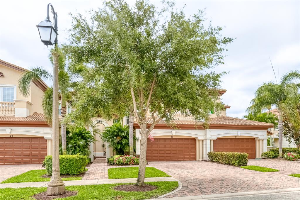 Impressive ground floor, lake view, 2 Bedroom 2 Bathroom condo with an additional den/office. Open Floor plan with over 2100 sq. ft. of living space and located within walking distance to the Sports Club. Built with many custom features and upgrades including Plantation Shutters on all window,, upgraded baseboards, crown molding and door casings, Whirlpool Gold Series appliances and under counter wine cooler. Impact windows, sliders and front door with side light. Glowing 52'' electric fireplace surrounded with 16x32'' porcelain tile. Stunning water views, quit, serene setting with tremendous sunsets.  The outdoor patio area has electric screens that adds extra outdoor living space to this home. Bose sound system in and outside. This maybe one of the most impressive units in the neighborho