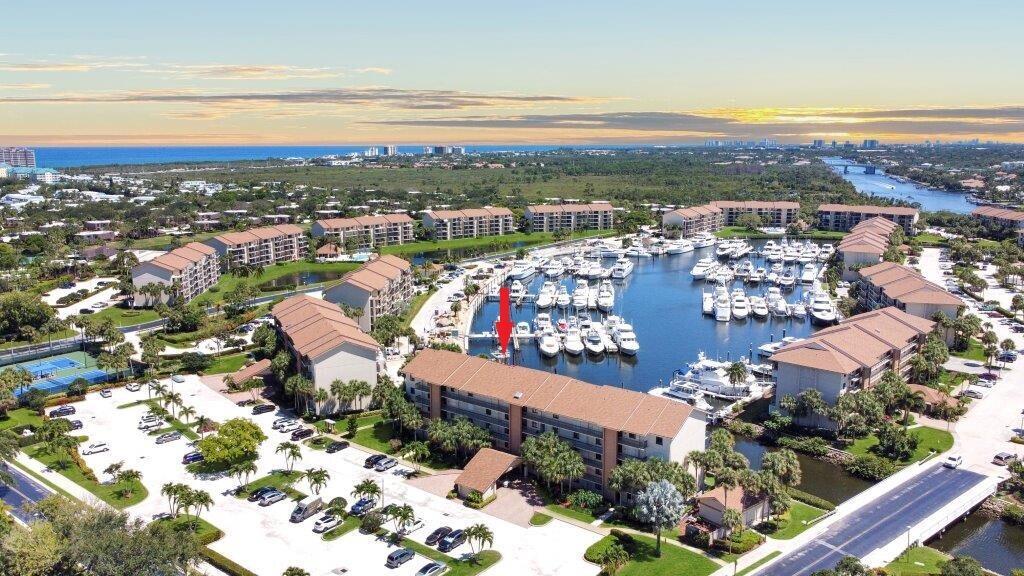 Within a short distance of the beach, this property offers a captivating waterfront view of yachts and palm trees. You can enjoy the outdoors on the spacious balcony, which provides both open and covered areas. Community boasts four pools located right by the water. Bathrooms and kitchen have been recently updated and are in pristine condition. Full laundry room with extra storage space and a Murphy bed. All of this is set in a tropical environment with a low homeowner's association fee. Highly sought after due to its prime waterfront location. Views of the marina and a glimpse of the Intracoastal. The location is just a minute's walk to one of the three pools overlooking the water, as well as pickleball and tennis courts. Publix shopping plaza, featuring a variety of shops and eateries.