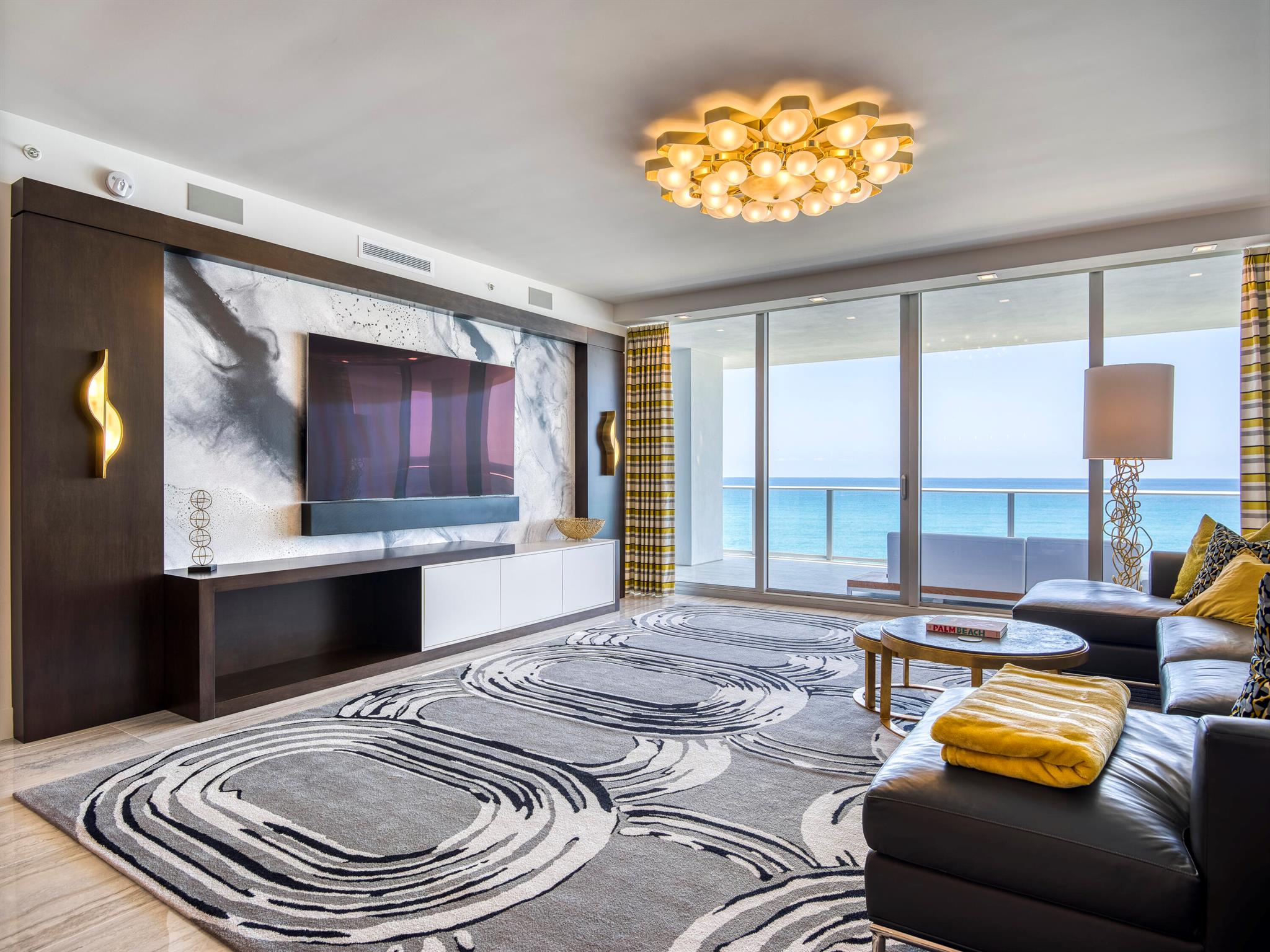 Take your private elevator to this dramatic, turnkey, retro-inspired oceanfront condo in the heart of Singer Island!  Featured in Florida Living Magazine and designed by ASID Design Award Winner, Lorraine Rogers, this oceanfront masterpiece features over $1 million in custom upgrades including geometric, veneered walls, custom silk and wool rugs, and lighting from all over the world to suit the needs of the homeowners who used the unit as their oceanfront pied-a-terre.  Additionally, the entire unit was pre-wired for Control 4 and Lutron technology which allows you to control music, TVs, blackout shades, drapery, lighting, wireless thermostat from your mobile device, installed control panel and touch panels throughout the unit.  Watch the magnificent, unobstructed sunrise over the Atlantic