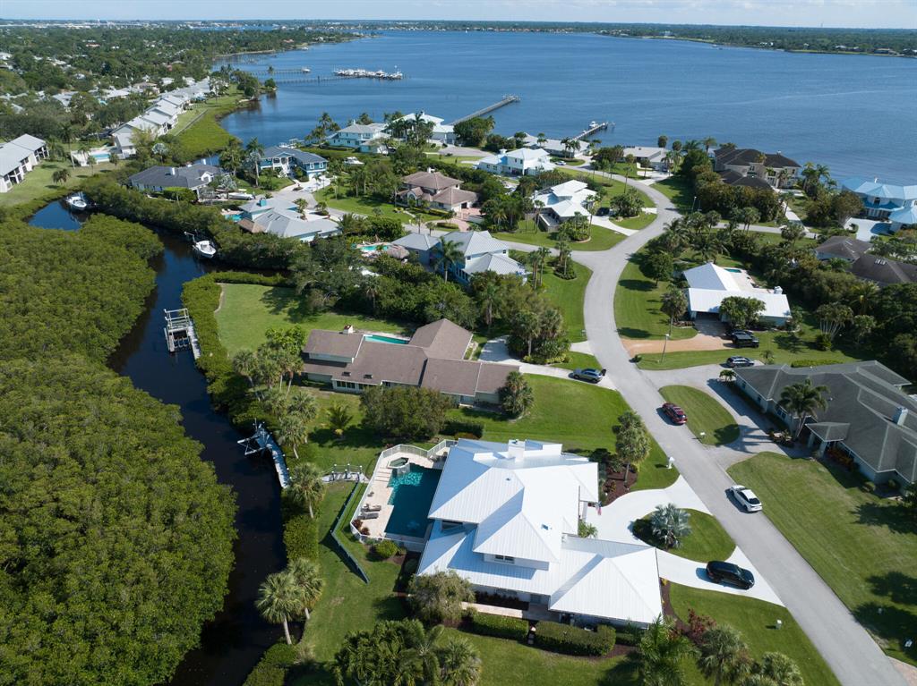 Great architecture meets South Florida waterfront living. This is a rare opportunity to own a custom home designed by Kelly and Kelly Architects. Over a half-acre of luxury and privacy in Bay Colony.Grand entry, soaring ceilings, clear story windows. The WOW factor with marble gas fireplace, architectural beams and open floor plan.Amazing ocean-access waterfront location with scenic water and nature preserve views. Resort-style pool, raised hot tub, travertine marble patio beautifully sealed for Florida outdoor living. Outdoor shower. Landscaped for complete privacy. Your private dock is ready to go with boat lift, water, power, synthetic decking. Easy access for paddle boarding, kayaking and canoeing as well. First floor master suite leads to screened patio and private pool. Beautifully updated, spa-like master bath with separate shower, soaking tub, dual sinks, vanities, walk-in closets. Second bedroom on the ground floor with spacious bath and enormous laundry room. 

Three spacious bedrooms, screened balcony overlooking your incredible property and waterfront on the second floor. 

Start cooking in your contemporary chef's kitchen. Granite counters, Shaker style cabinets, glass tile back splash and counter seating. Electric appliances, convection cooktop. Formal and casual dining.

Your insurance provider will love you with this metal hip-roof design, concrete block construction, impact rated glass sliders plus accordion shutters, at high elevation. Dual zone, high efficiency HVAC. In-ground propane gas. Whole home water conditioning system. Central vacuum. Circular driveway, oversized two-car garage.

Easy access to the best of Stuart and Martin County. Public docks downtown, top-rated schools, outstanding restaurants.  Pristine beaches, public parks, sand bar and so many cool places for boaters. 

Call for private showing. Floor plan is available upon request.