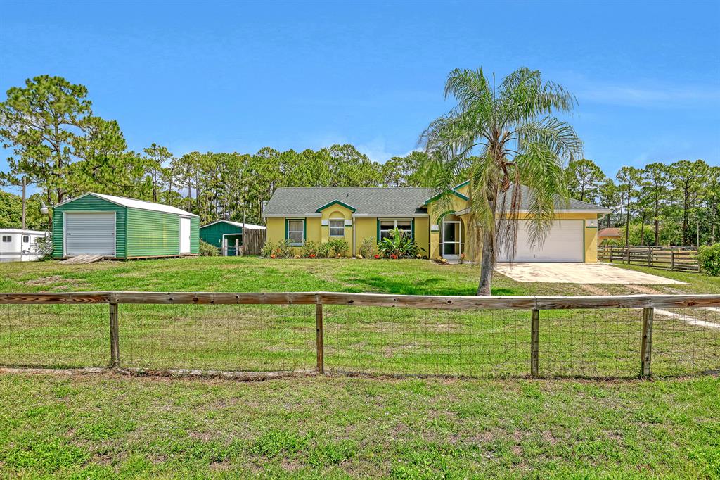 Adorable mini horse farm on 2.28 acres located in the heart of Loxahatchee, The home offers an open concept with a split bedroom floor plan. Brand new carpets in all 3 bedrooms, and tile throughout the main living areas. There is a front screened-in porch and a huge screened (2019)patio in the rear which is the full length of the house. You will love bringing your horses here with a 3 stall barn with separate feed and tack room (24 x 60)built in 2006 includes hot water, and electric lights. The property includes arena with 4 lights perfect for night training, 3 run-in sheds ( 12 x24) with roofs replaced in 2021. The lot is crossed fenced and can be designed to fit your equestrian needs. There is also a wash stand and shed on the property.  New septic 2018