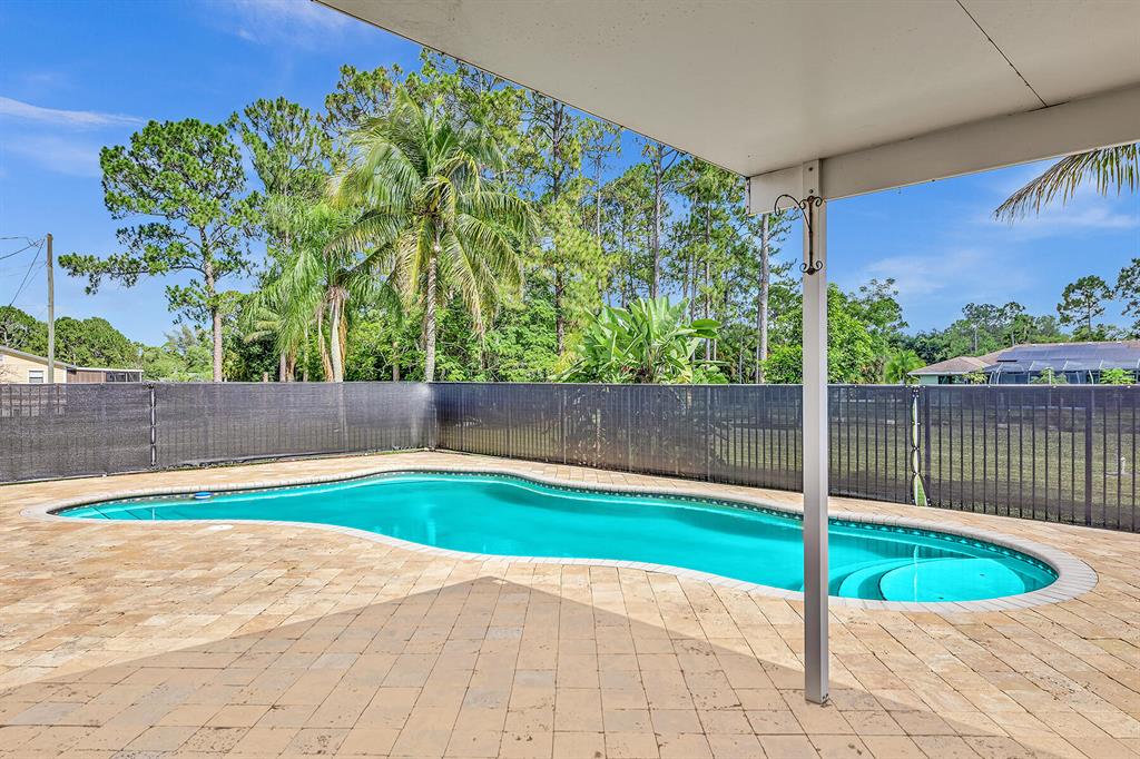 NO HOA ****.  LOCATION !!  LOCATION !!  LOCATION !! BEST PRICED 3 BEDROOM 2 BATHROOM POOL HOME  HOME IN LOXAHATCHEE  ***.  NO HOA- BRING THE RV, BOAT, TRAILER, PETS AND HORSES !!!  LOTS OF ROOM FOR GUEST HOUSE, WORKSHOP ***. PAVED ROAD **. METAL ROOF **.