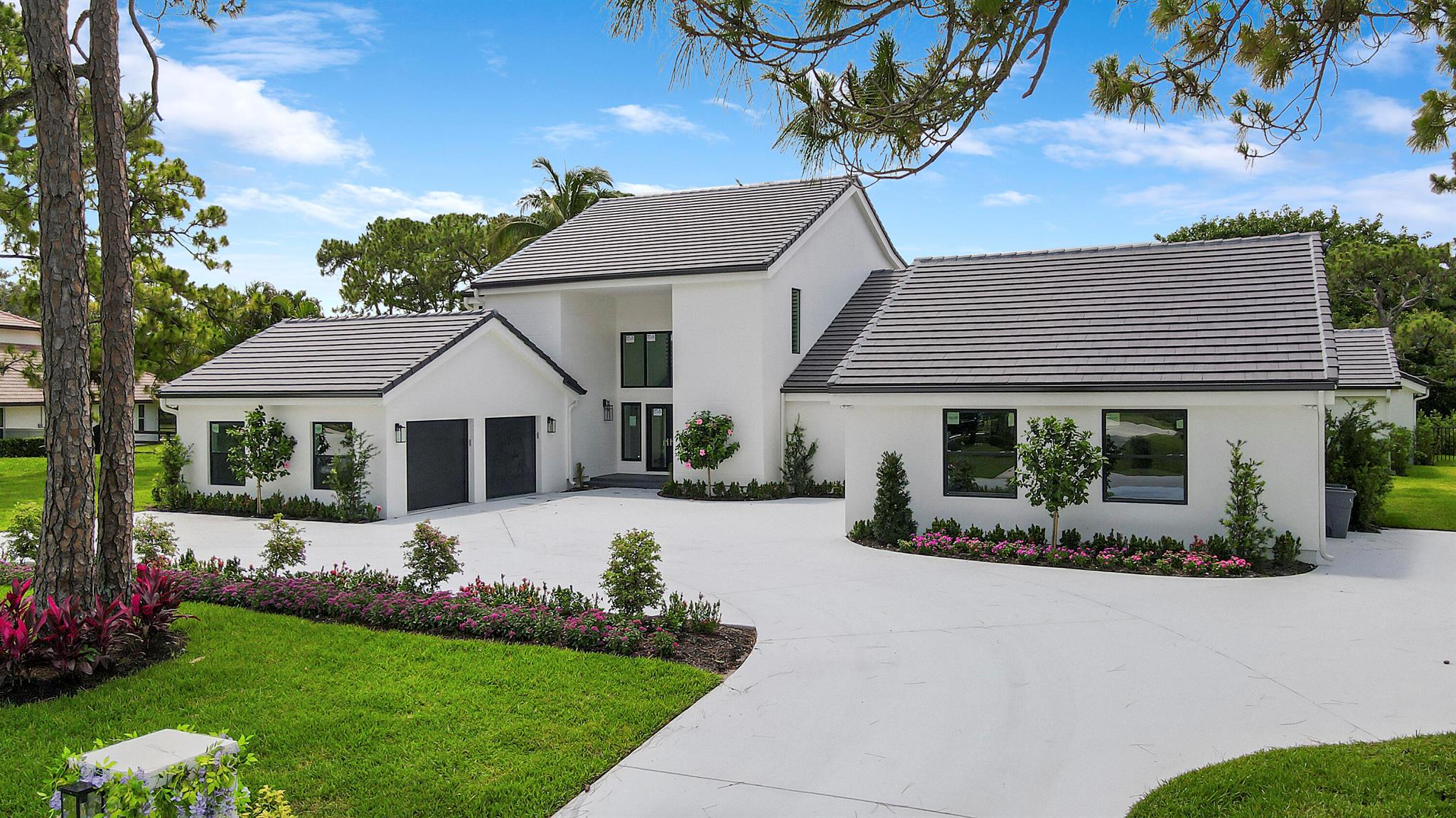 This custom estate home in the prestigious gated community of Steeplechase in Palm Beach Gardens has it all. The luxury residence has been completely rebuilt in 2023 and offers 5,642 living square feet with modern finishes, beautifully appointed amenities, and 5 bedrooms, 5.5 bathrooms plus a flex space currently designed for a home theatre. In-home features include a huge, expertly equipped kitchen with massive double islands and a double sink, a spacious wine cellar, fireplace feature in the living room, and an upstairs loft perfect for a game room or work space. The primary bedroom is bright and open with a spa-like en-suite, private screen porch, and a large walk-in closet with island. All the bedrooms and bathrooms in this residence are spacious and beautifully appointed.