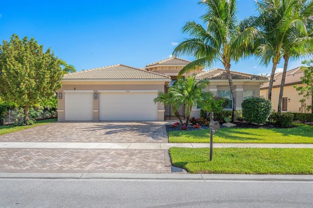 Enjoy resort living and spectacular lake views from this beautiful Charleston Grande in the Crown collection Capri section of Valencia Cove. This one story floor plan is the largest floor plan offered in Valencia Cove and features 3 bedrooms (one currently set up as an office), club room, formal dining, living room and a 3-car garage. This home is on the widest lake in the community. Highlights of this home include: model kitchen, 24x24 polished porcelain tiles throughout (no carpet), extended garage, extended driveway and patio, Hunter Douglas window treatments and front entry gate. This premier 55+ community offers a sprawling clubhouse, bistro with table service dining, sports facilities, 4 pools, fitness center, card rooms, tennis, pickle ball, bocce courts and 2 gated entrances.