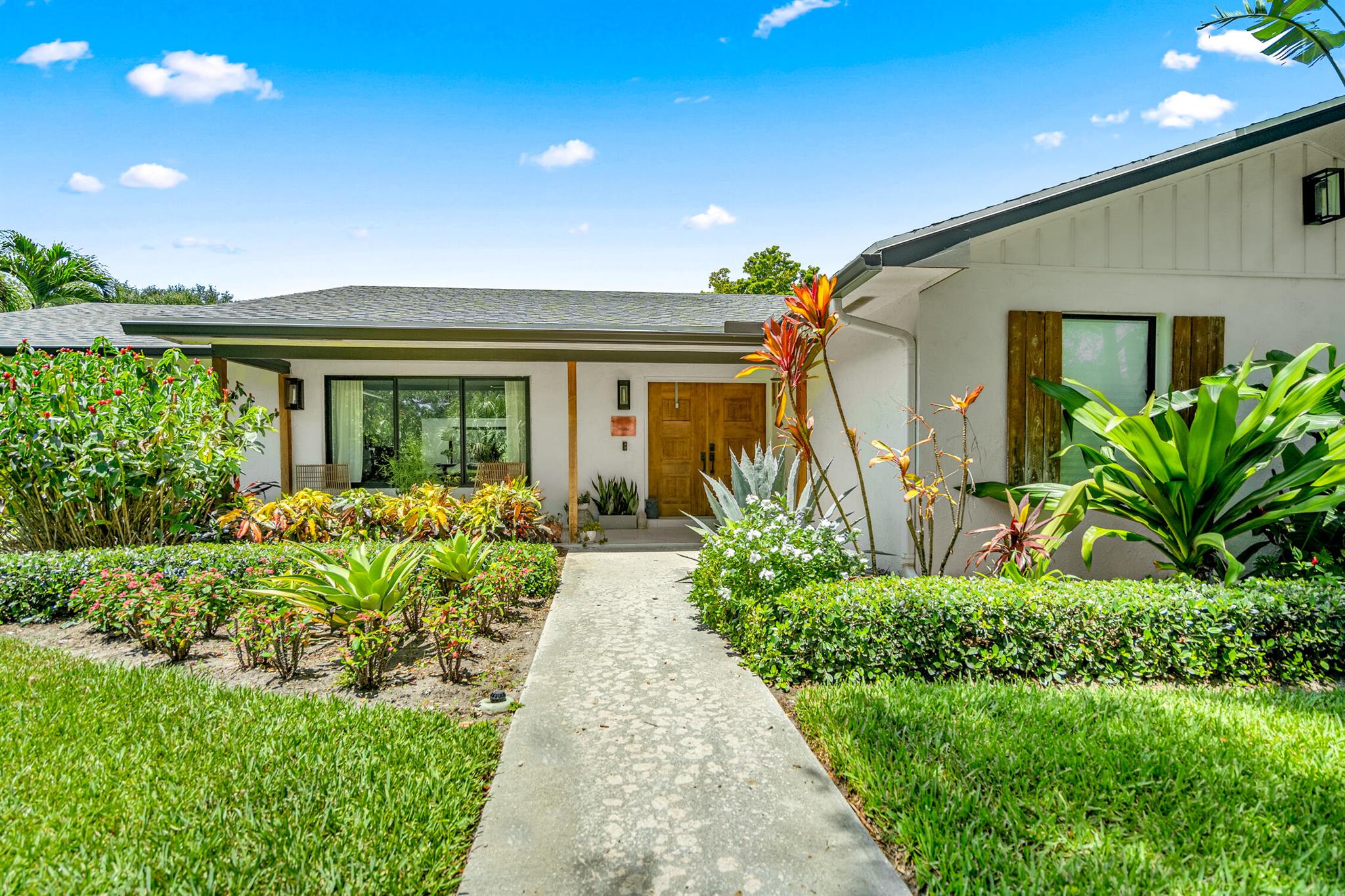 Welcome to your private 1.42 acre paradise in the middle of Palm Beach Gardens.  This newly renovated, contemporary ranch style ''smart'' pool home has tranquil, California vibes nestled on an expansive 1.42 acre lot. in a private cul-de-sac. Enjoy your designer styled home, complete with luxury features throughout.  Experience true Florida living with tons of natural light. Spacious living and dining areas with stunning custom lighting fixtures overlook a beautiful bright kitchen, complete with modern Italian cabinetry and Schwinn hardware.  Gorgeous calacatta quartz countertops with a custom waterfall edge and a bar pass through for entertaining. All Bosch appliances, including built in coffee bar. Huge 12 x 24 Italian porcelain tiles throughout elevate the contemporary style Relax in the spa like en-suite bath-complete with double sinks overlooking the landscape.  Grab your favorite book and enjoy the free standing soaking tub plus expansive shower wet room. Off the owners suite is a complete bedroom/den/office plus full bath. The split bedroom plan is perfect for privacy, with two bedrooms plus full bath on the other side of the home.  Smart home features include Nest thermometers for both a/c units, Ring doorbell and cameras, built in wifi booster plus reverse osmosis water system for the kitchen and laundry.  Venture outside and enjoy an incredible back yard oasis, complete with salt water pool and tropical tiki hut.  This home truly has it all- turn key perfection!