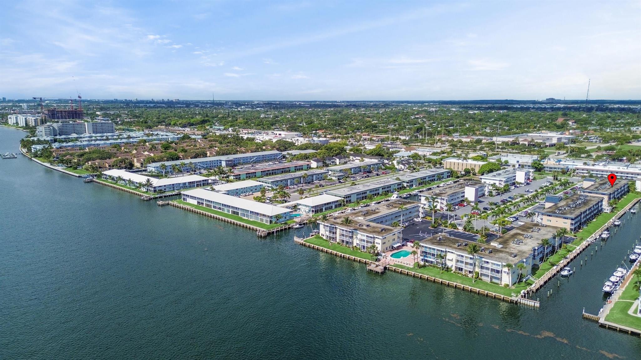 Prime Location for Boaters! This exceptional 2-bedroom, 1-bathroom first-floor unit in a vibrant 55+ Community in North Palm Beach offers a delightful coastal ambiance after a complete remodel. Wake up to awe-inspiring sunrise views of the Intracoastal and enjoy enchanting evening skyline vistas of Singer Island. Featuring impact windows and doors installed in 2022, neutral tile floors, spacious walk-in closets in both bedrooms, and a recently updated kitchen and bathroom (2021), this co-op is move-in ready. The air conditioning unit is approximately 5-7 years old, and a new water heater was installed in 2022.Convenience is key, as this charming unit is situated close to beaches, shopping destinations, the North Palm Beach Country Club and Recreation Center, major highways, and just minutes away from PBI Airport. Please note that this is a 55+ Community and pets are not allowed. Cash is required for purchase since it is a cooperative.

The well-maintained building offers an array of amenities, including a recently renovated heated pool, a clubhouse, and grilling areas for entertaining. Each unit boasts a balcony or patio overlooking the canal adjacent to the Intracoastal. You'll have the opportunity to dock your small boat at a reasonable monthly rate on a first-come, first-served basis, with a potential waiting list.

Conveniently located right in front of the unit, assigned parking space #18 adds to the ease of living. Please review the disclosure in the documents section, which includes the Proprietary Lease. The building's reserves total over $350k, and there have been no special assessments in over 10 years, offering peace of mind to residents. Rentals are permitted after 24 months with approval from the Board. Don't miss out on this incredible opportunity!
