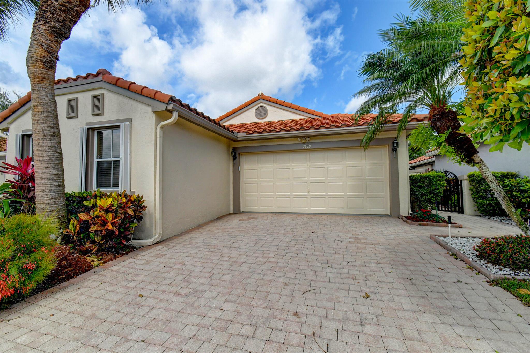 Welcome to 7488 Granville Ave in Boynton Beach, a remarkable residence for sale in the highly desirable 55+ community of Cascades. This exceptional property showcases the rarely available Windsor Model, which boasts the largest floor plan in the esteemed Wedgewood Village. Spanning almost 1700 ac square feet, this elegant home comprises 2 bedrooms, 2 bathrooms, and a den, offering ample living space for the discerning buyer.Upon entering, you are welcomed into the inviting great room, thoughtfully designed for entertaining and social gatherings, leading to this oversized screened patio.  Whether you're hosting intimate dinner parties or enjoying quality time with loved ones, the great room serves as the ideal centerpiece for creating cherished memories in the comfort of your own home, The eat-in kitchen, complete with a built-in desk is ideal for culinary enthusiasts and those who appreciate functional design. The kitchen seamlessly transitions to a generously sized screened patio, extending the length of the home and providing a serene outdoor retreat.

The main bedroom is a true haven, featuring a sizable walk-in closet equipped with built-in organizers, ensuring optimal storage and organization. The en-suite bathroom boasts his and hers sinks, a shower, and a tub, along with the added convenience of pull-out drawers in the cabinets.

The thoughtfully designed split bedroom layout guarantees privacy for both residents and guests alike. The second bedroom, located at the end of the hallway, welcomes abundant natural light through its two east-facing windows, creating an inviting and airy atmosphere. Additionally, the den, with its pocket doors, offers versatility and ample space to accommodate an office area as well as a pull-out couch.

This home has been updated with several noteworthy features, including accordion shutters for effortless hurricane protection, tasteful tile on the diagonal, a newer refrigerator, an air conditioner replacement in 2020, a water heater update in 2014, and a roof replacement in 2009. These updates enhance the home's functionality and ensure peace of mind for the discerning homeowner.

Cascades is renowned for its exceptional amenities, including a remodeled club, captivating shows, a refreshing pool, a well-equipped fitness center, and tennis courts, among other offerings. The on-site caf+¬ serves delightful breakfast and lunch options, adding to the convenience and enjoyment of the community. As a non-equity community adjacent to the esteemed Westchester Golf Course, Cascades offers an unparalleled living experience reminiscent of a five-star resort.

Recently, the clubhouse underwent an extensive renovation, further enhancing the community's appeal. The maintenance package includes exterior painting, roof cleaning, basic cable services, and high-speed internet, ensuring a hassle-free lifestyle for residents.

Don't miss this remarkable opportunity to own a luxurious and meticulously maintained home in the coveted Cascades community. Schedule your private viewing today and immerse yourself in the epitome of elegant 55+ living.

