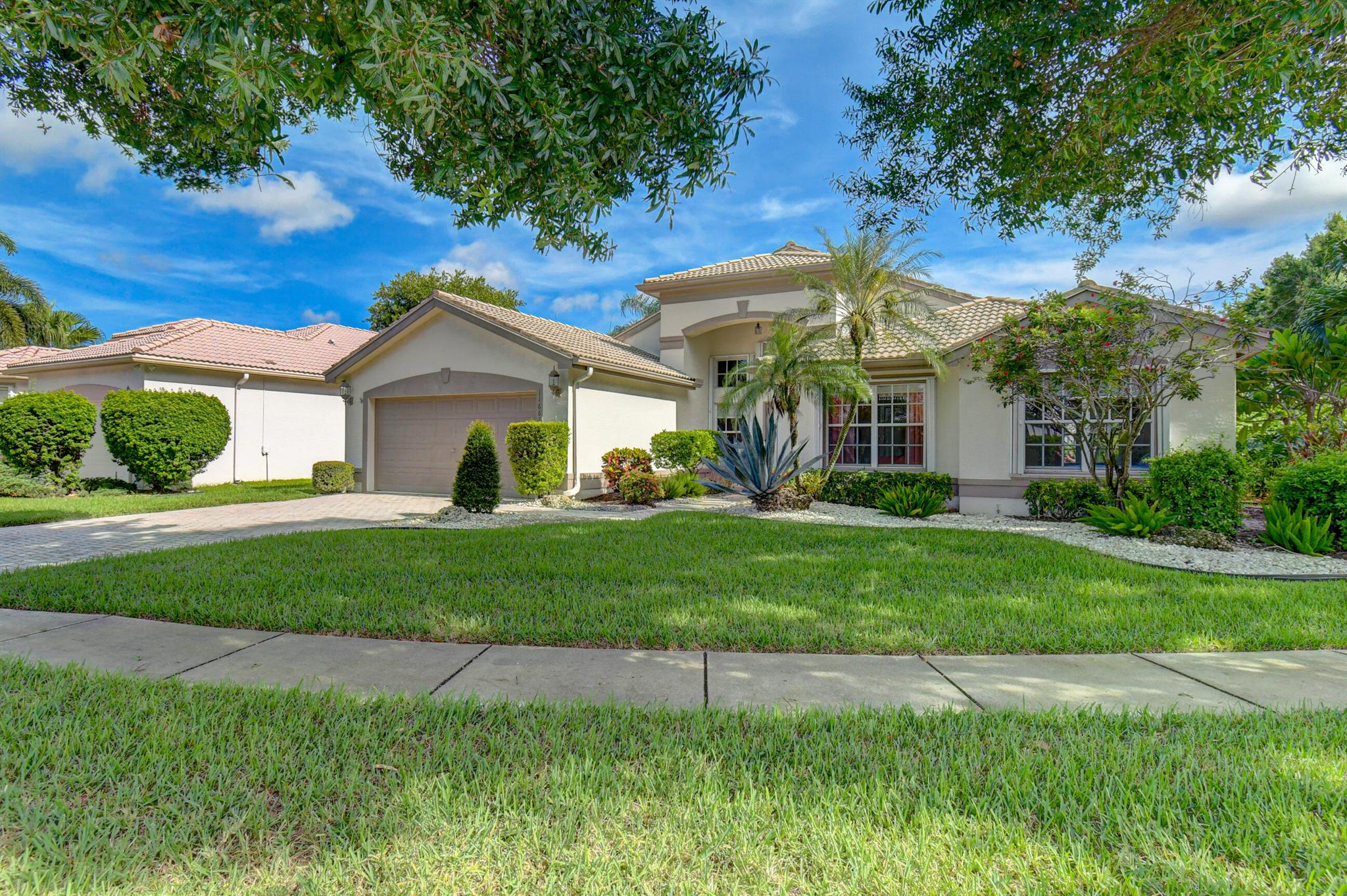 Every day is more beautiful in this sophisticated and spacious home located on an oversized private corner lot in gated Valencia Lakes resort-style community. Former model home offers open-concept floor plan featuring a host of updates and upgrades plus the peace of mind of accordion hurricane shutters. Open kitchen features custom cabinetry, stainless steel appliances, seated bar for casual dining. Dramatic owner's suite features patterned tray ceiling and includes en suite bath featuring dual sink vanities, separate tub and walk-in shower plus direct terrace access.Valencia Lakes amenities include clubhouse, cafe, fitness studio, on-site manager, pickleball, tennis, & spa