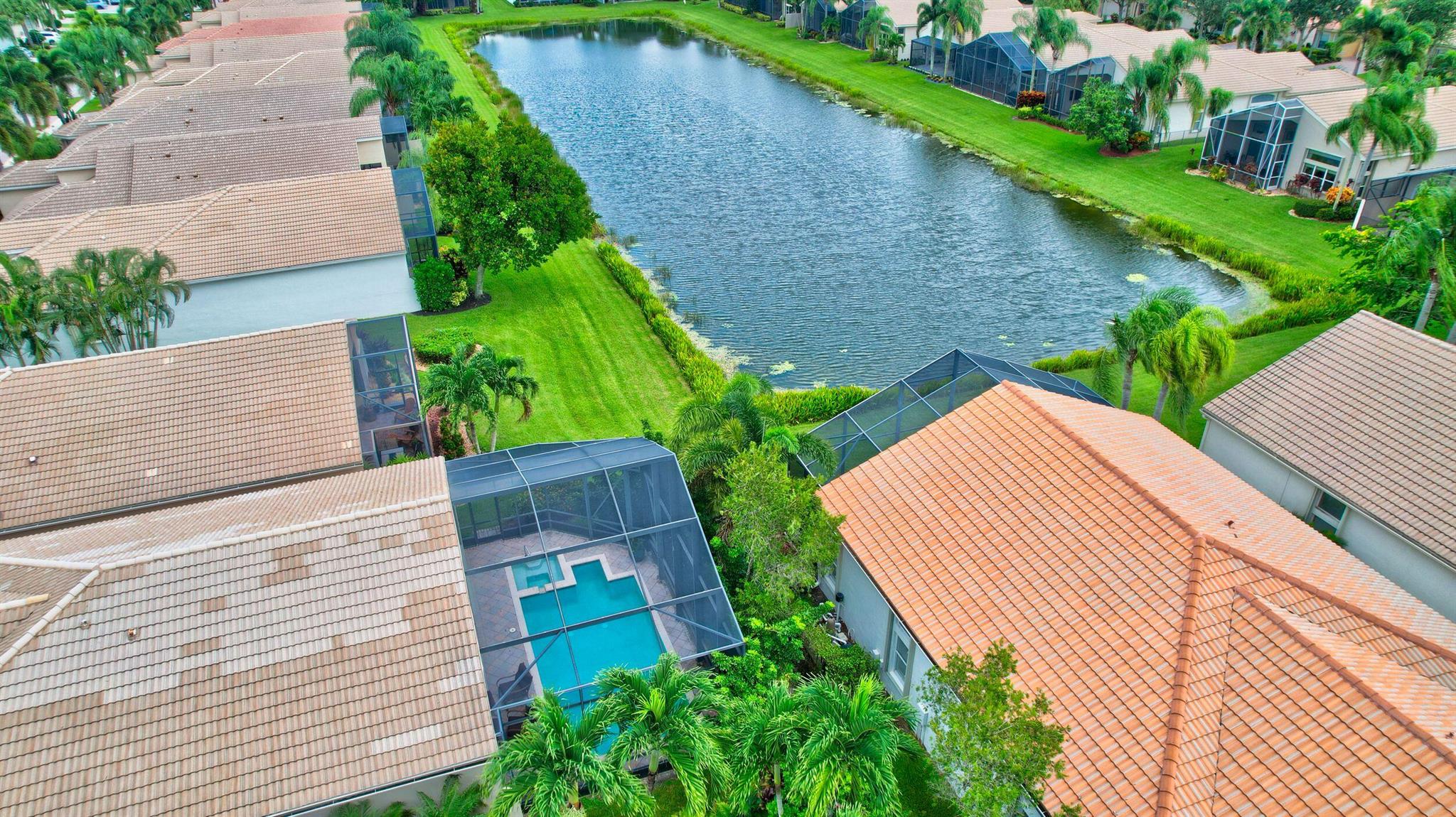The largest and most ACTIVE 55 plus VALENCIA Community in the Boynton Beach area! TWO clubhouses, a Cafe, tennis, pickleball, Beauty Salon++. South Florida living with a very private extended screened pool/patio area on the lake.  This beautiful FURNISHED Indian model has 3 bedrooms (one is a den) and 2 full and one-half bath. The two guest rooms access a private bathroom. Floor plan attached.  Transom windows bring in light from the Southern rear exposure. The kitchen has wood cabinets with pot and pan drawers and double wall ovens. Crown molding, plantation shutters & high hats. Master custom fitted closets.Furnished. HOA fees cover landscaping, TWO clubhouses and cafe, painting of home is done every 5 years, Internet, HD TV with 1 DVR, alarm, and phon