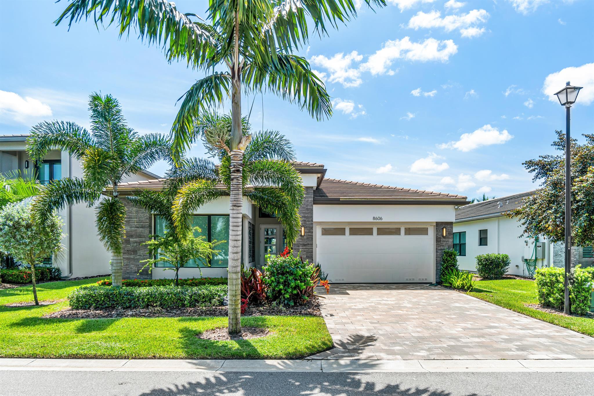 Elegantly upgraded Tahiti model on a premium lake lot in Lotus. Upon entering this lovely home you are greeted with Italian Porcelain 24 x 48 Tile Floors, 8'' moldings and vaulted entry ceilings. The expanded great room provides countless options for entertaining. The spacious primary bedroom and bath provide the perfect retreat with it's French doors leading to the covered patio and yard. Beautiful finishes throughout and too many upgrades to list make this home a standout in contemporary one story living. Outdoor is plumbed for future pool and summer kitchen. Furniture negotiable.