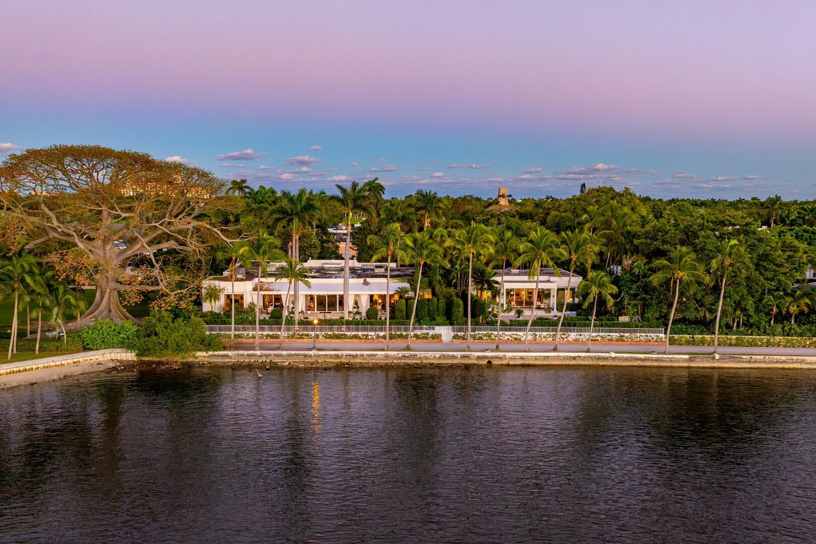 Fantastic Lakefront In-Town property with 200'+/- along the Intracoastal. Stunning water views throughout this one story estate. 8 bedrooms, 8 full baths, and 2 powder rooms split between main residence and guest house. The main estate features high ceilings, grand living room with fireplace, formal dining room, and family room with wet bar. Beautiful tropical landscaping surrounds terraces, swimming pool, and spa. Dramatic view of the kapok tree. Spectacular sunset, Intracoastal, and downtown views.