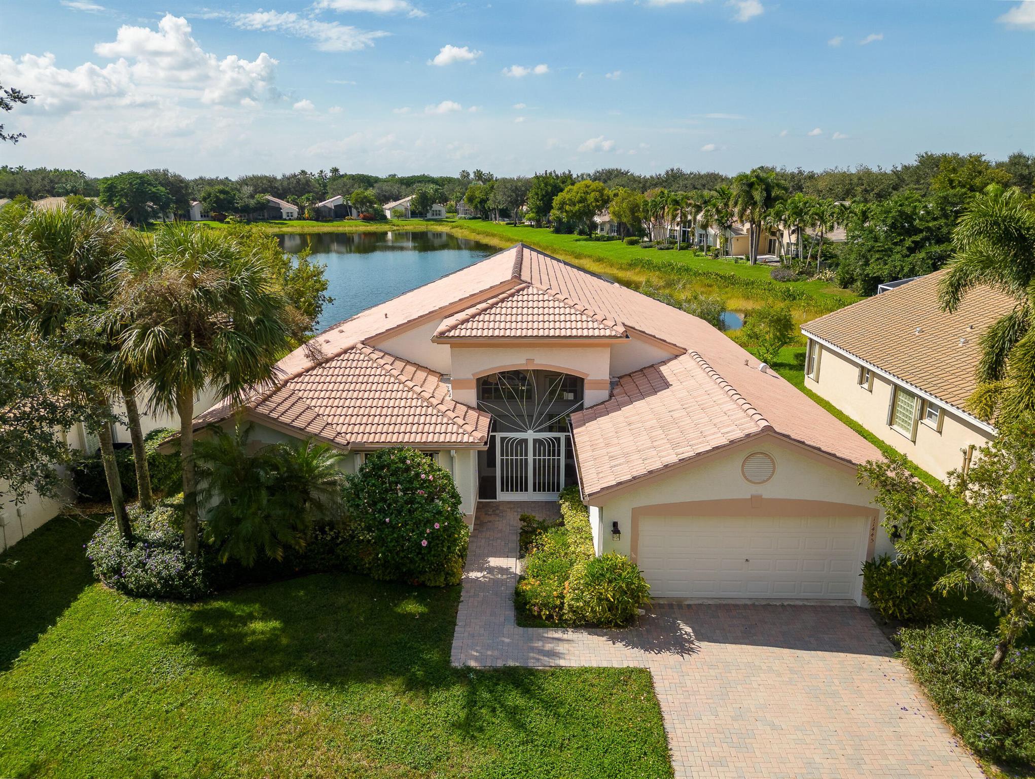 Stunning Long Lake View on Entry! This highly sought after light and bright Granada model is move-in ready! The home features 3 bedrooms (3rd bedroom is currently being used as an office & closet area has a built in desk), 2 baths w/ an extended laundry area and over-sized lanai!. Upgrades including but not limited to 2020 A/C, 2022 Hot Water Heater, wood cabinets in the kitchen, granite countertops, beautiful French Doors leading to the office, tile on the diagonal throughout the main living area & office.  Water view & outdoor access from primary bedroom, living & family room.  Private long lake view w/ lanai perfect for relaxing or entertaining family & friends. Valencia Isles recently renovated clubhouse w/ Bistro has activities and amenities to keep you busy all week long! Video