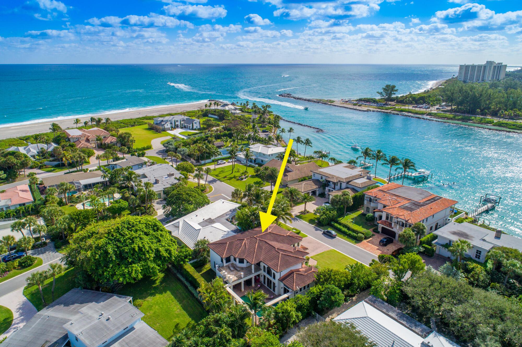 Welcome to this stunning Mediterranean-style coastal residence located in the highly-sought after Jupiter Inlet Colony. Enjoy being steps away from the private Beach Club, the Jupiter Inlet & the gorgeous turquoise ocean waters! Custom built in 2007, this magnificent 5 BD/5.5 BA concrete home with impact windows & doors was impeccably constructed with the finest design, craftsmanship, and functionality in mind. Enter this elegantly designed home and marvel at the abundance of natural light, arched windows, trey ceilings, marble and hardwood floors, custom woodwork, and much much more!  The gourmet kitchen features top-of-the-line stainless steel appliances, including a commercial-grade 8-burner gas stove and custom wood cabinetry. The upstairs master suite, complete with a sitting area... ... and a large balcony boasting views of the inlet and Intracoastal, is a serene retreat within the home.  This prime location offers easy access to the beautiful beaches, marinas, and world-class golf courses that the Jupiter area is renowned for. This exclusive community with the area's only private beach club provides 24/7 security, ensuring your peace of mind. Don't miss the opportunity to make this exceptional property your own!