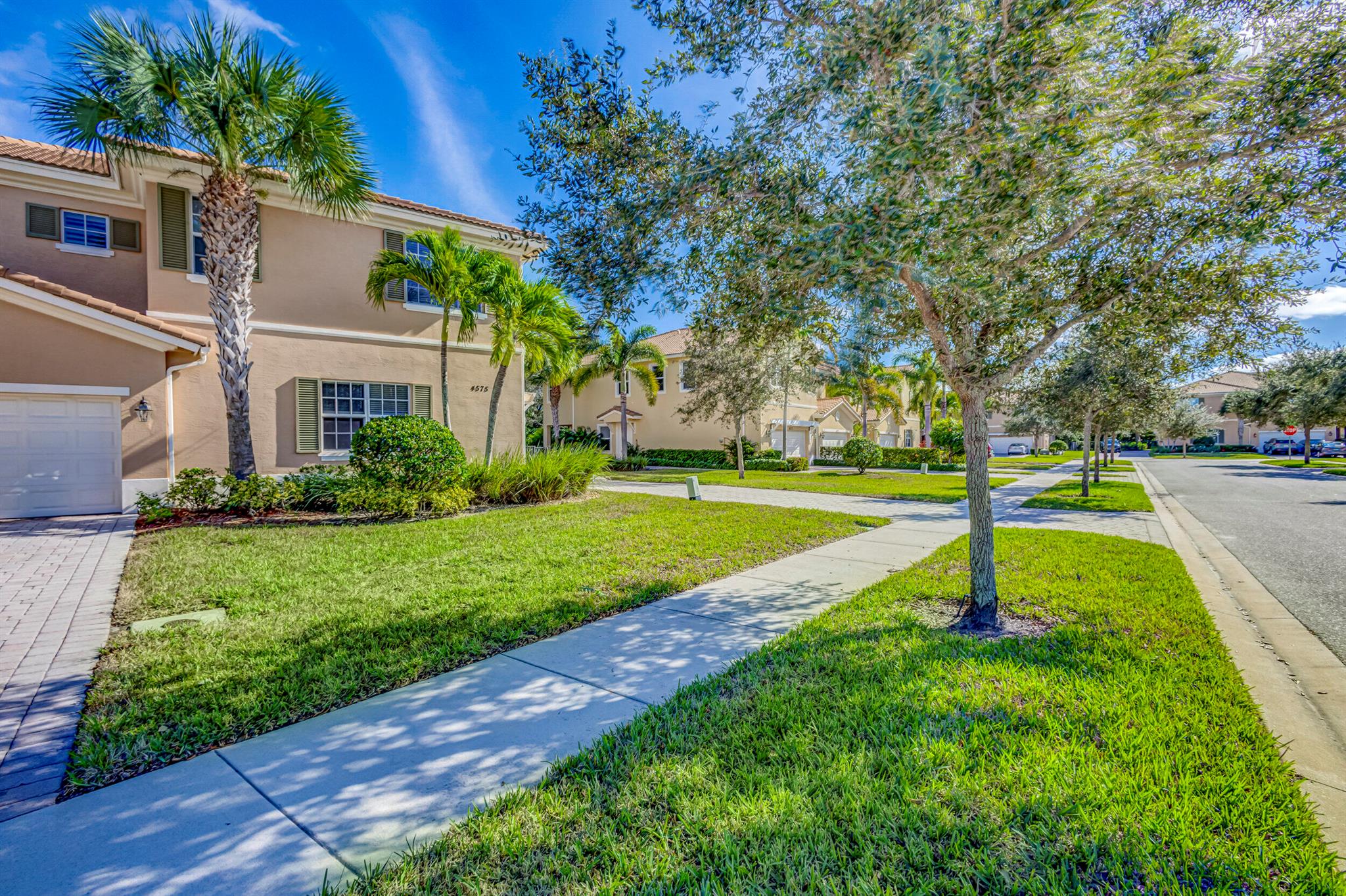 Beautifully kept, upgraded and freshly painted corner unit townhome in the highly desirable Paloma Palm Beach Gardens. Built by Kolter homes this unit has concrete block construction on both levels and hurricane rated impact windows throughout. Upgrades include granite and stainless steel appliances, crown molding and plantation shutters  Large walk in closet with built-ins in the master bedroom and hardwood floors through the upstairs. The large loft can be used for a game room, play room or media room/office. This particular unit has the biggest fenced in back yard in entire development with expanded paver deck. Two car garage and oversized 6 car driveway.