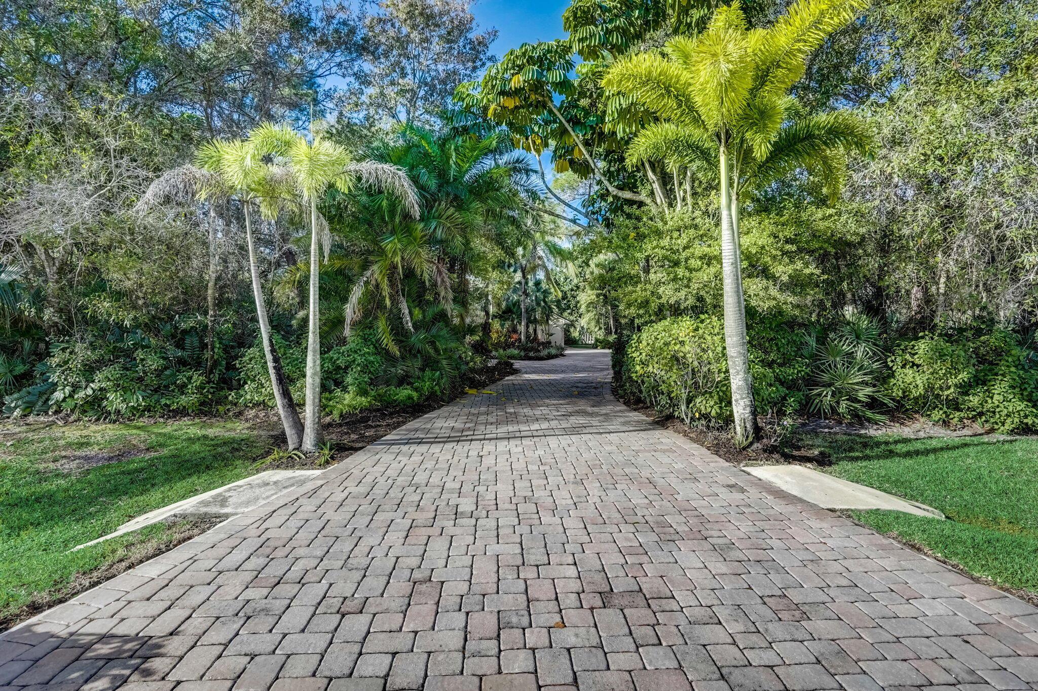  Exceptional 3-bedroom, 2.5-bath single-level pool home, situated on a sprawling 1.45-acre estate within the highly sought-after gated community of Crane Creek in Palm City. 

Step through the double front doors into your formal living and dining room, offering a seamless view of the tropical pool oasis. The vaulted ceilings and spacious open concept split floor plan create a harmonious balance between privacy and communal living.  Enjoy the pleasure of entertaining year round and relaxing on your spacious screened-in patio, complete with a generously sized covered lanai, large heated pool, an outdoor shower, and a separate entry leading to two guest bedrooms.

Retreat to the primary bedroom suite where volume ceilings, combined with glass sliders, infuse the space with natural light and establish a private connection to the outdoor space. The spa-like en suite bath boasts a separate tub, a custom shower with a private garden view, complemented by a large walk-in closet with built-ins, adding a touch of luxury and practicality to this ground-level suite.

Discover the added perks of this residence, featuring a custom driveway with ample parking, an oversized 2-car garage with a dedicated workspace, and a 2017 metal roof for lasting durability. The tile and wood flooring throughout ensure low maintenance, eliminating the hassle of carpet care. While membership to the Village Club &amp; Preserve and Martin Downs golf club are available, it remains optional, granting you the freedom to customize your lifestyle to your desires. Zoned for "A" rated Palm City schools with easy access to both I-95 and the Florida Turnpike, this home epitomizes comfort, luxury, and the authentic Florida lifestyle.