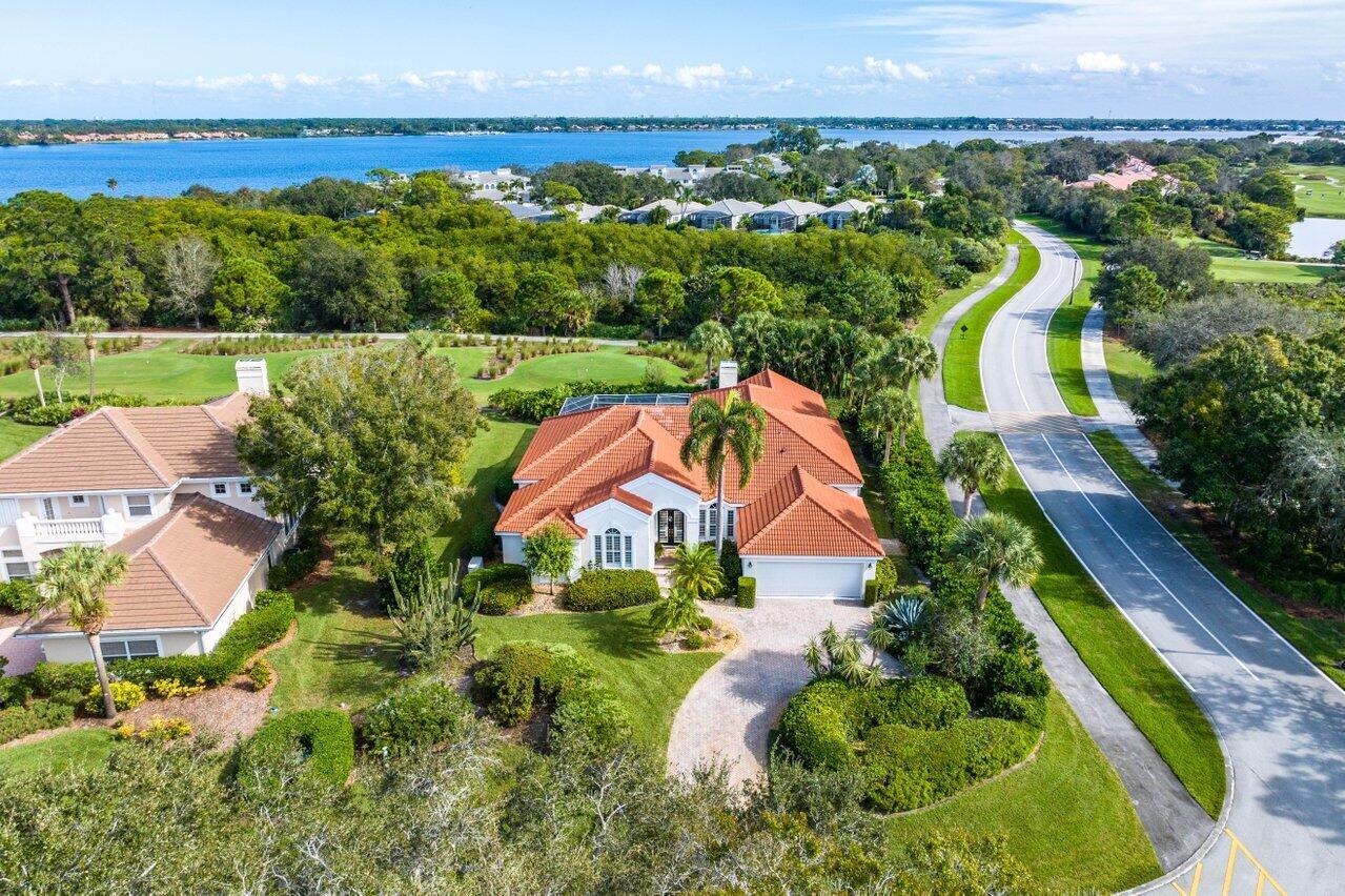 Custom home in the estate section of Harbour Ridge Country Club. As you walk in you will feel the height of the ceiling and all of the natural light this residence has to offer. You have amazing views of the golf course and St. Lucie River. The floor plan is split with the primary suite and den/office to the left as you enter the home. In the primary suite you have views of the pool, dual closets (one walk-in), dual sinks, makeup area, soak tub, separate shower, and volume ceilings. You have a living room and large family room offering lots of flexibility. The kitchen is oversized and provides nice open views of the living, lots of seating, a pantry, breakfast nook, and wet bar. The pool is screened and heated. There is a whole house Generac generator. Schedule your showing today.