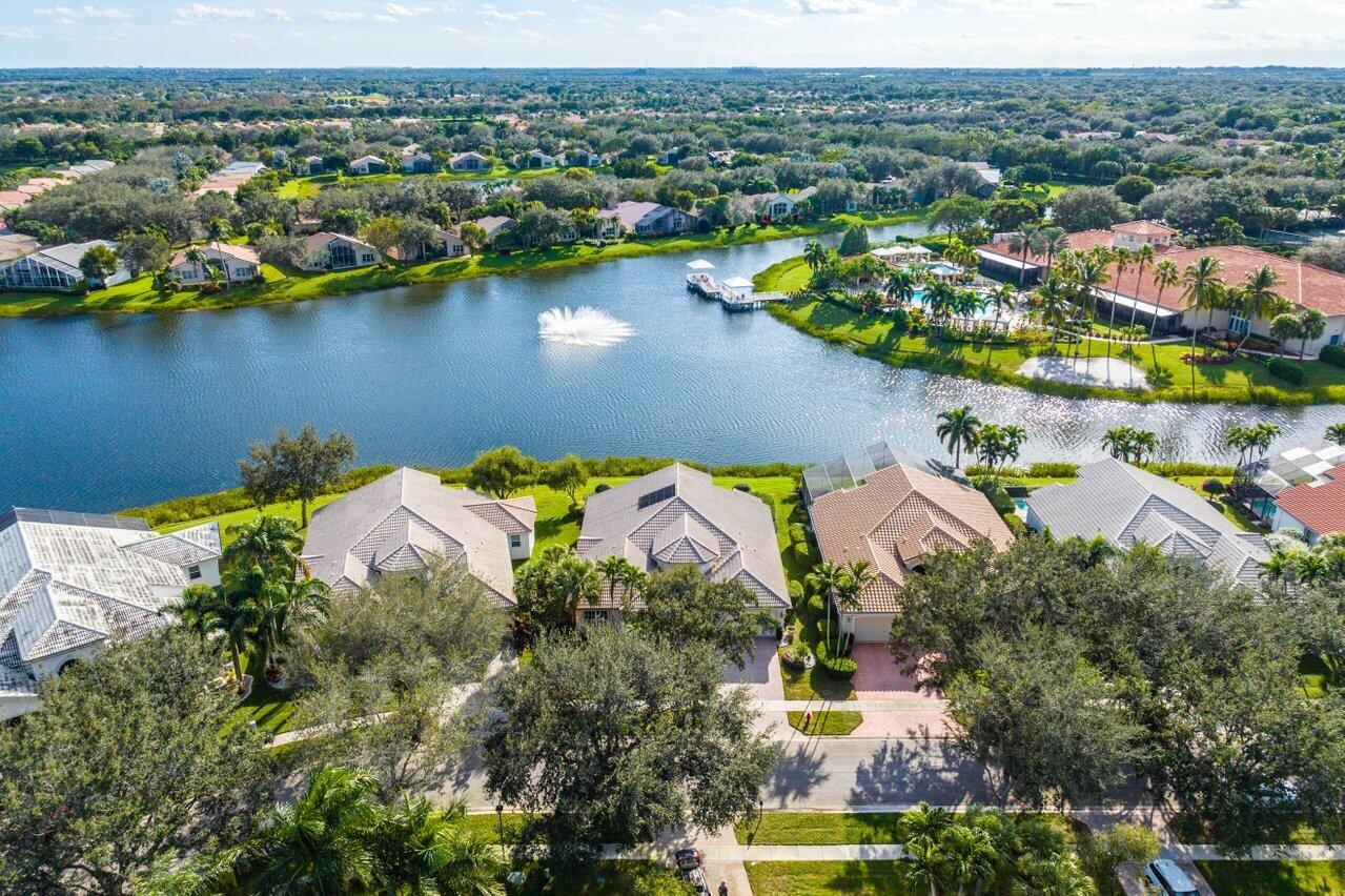 Welcome to Valencia Isles, a highly coveted, active 55+ community for those with who dare to make their dreams a reality!  This 4 bedroom, 2.5 bathroom, two-car garage home is one of the largest in the community. Beautifully remodeled and updated home including upscale kitchen and guest bathroom.  Split bedroom layout.  Elegant 1/2 bathroom.  Volume ceilings. Extras galore including recessed lighting, abundant storage, tile throughout, custom iron work, architectural niches, and accordion storm shutters.    BEST LAKE VIEW in Valencia Isles! Covered patio and ''endless'' extended patio with tropical landscaping.  New A/C (2021) and $10,000 roof credit.   Entering  through the front door, a true foyer directs you toward the formal living room with high ceilings and a wide open view of