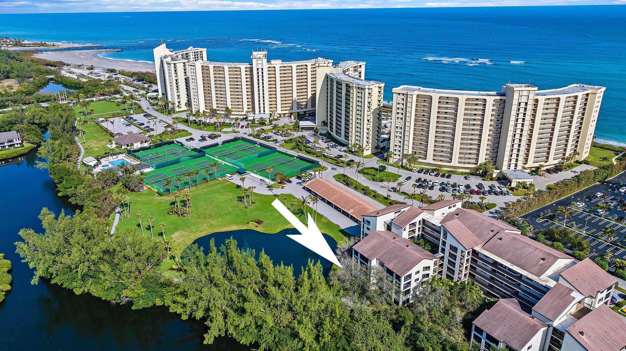 OWNER WILL PAY 2024 HOA DUES!Large 2/2 condo with private beach access just 300 steps from the building.  Location is great.  Walk to Publix, Cinopolis, Harborside, Guannabannas, Utiki and Square Grouper. 24 hour security at gate.First floor with pond view overlooking the estuary. Bathroom and kitchen remodeled.Friendly garden building with only 52 units.Tennis courts with pro available.  Men and womans sauna in the building. One of the few places you do not need to cross a busy street to get to the beach! Located behind Jupiter Beach Resort. Enjoy fine dining, spa and tiki bar there all year round.