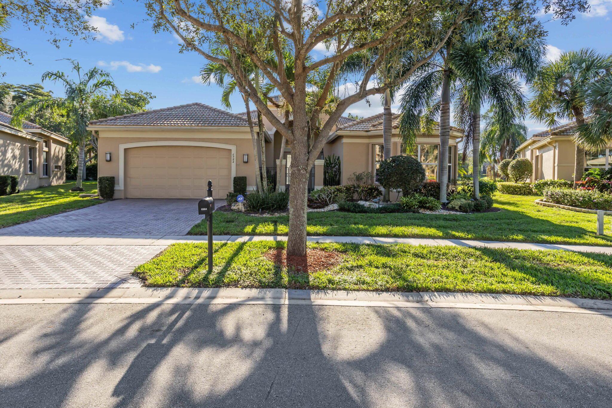 Discover the charm of this exquisite home, a true gem in the heart of Boynton Beach's Valencia Pointe community. This 3-bedroom, 2.5-bath haven is a lakefront beauty, offering a one-of-a-kind retreat for those seeking luxury and comfort. As you enter through the double glass hurricane doors with a modern design and new hardware, you're greeted by the timeless beauty of this Pamplona model. The hurricane arched window above adds a touch of sophistication, while accordion storm shutters ensure peace of mind throughout the entire home. Inside, bask in the glow of recessed lighting and crown molding, with 20x20 beige, white lace porcelain tile seamlessly flowing through the house. Granite countertops in the kitchen and baths, coupled with a cultured marble tub in the master bath, reflect a commitment to quality. Enjoy the convenience of HUGE walk-in custom closets, custom window treatments, wood blinds, and a sink and fridge water purifying system. The kitchen is a culinary masterpiece with a beautiful custom island, offering extra storage and outlets. The garage boasts epoxy flooring, adding a touch of luxury to everyday living. Step outside to a completely private backyard overlooking the largest lake in the development - a rare and peaceful retreat. The front yard enjoys a unique advantage with no house in front, enhancing the exclusivity of this property. Valencia Pointe offers a wealth of amenities, including a 35,000 square foot clubhouse surrounded by gardens and a stunning lake. Stay active with 6 Har-Tru tennis courts, a putting green, 4 Pickleball courts, 2 Har-True bocce courts, and a half-court basketball area. Indulge in the indoor spa with steam rooms, a facial/massage area, resort-style swimming pool, and whirlpool spa. This vibrant 55+ community provides an active lifestyle with over 100 social clubs, resort-style activities, and top-notch security with a manned gated entry. Exclusive "resident only" entrances add an extra layer of privacy. Benefit from HOA-covered amenities such as Hotwire fiber optic cable TV and Internet, ADT monitoring, lawn maintenance, irrigation system, and common area upkeep.