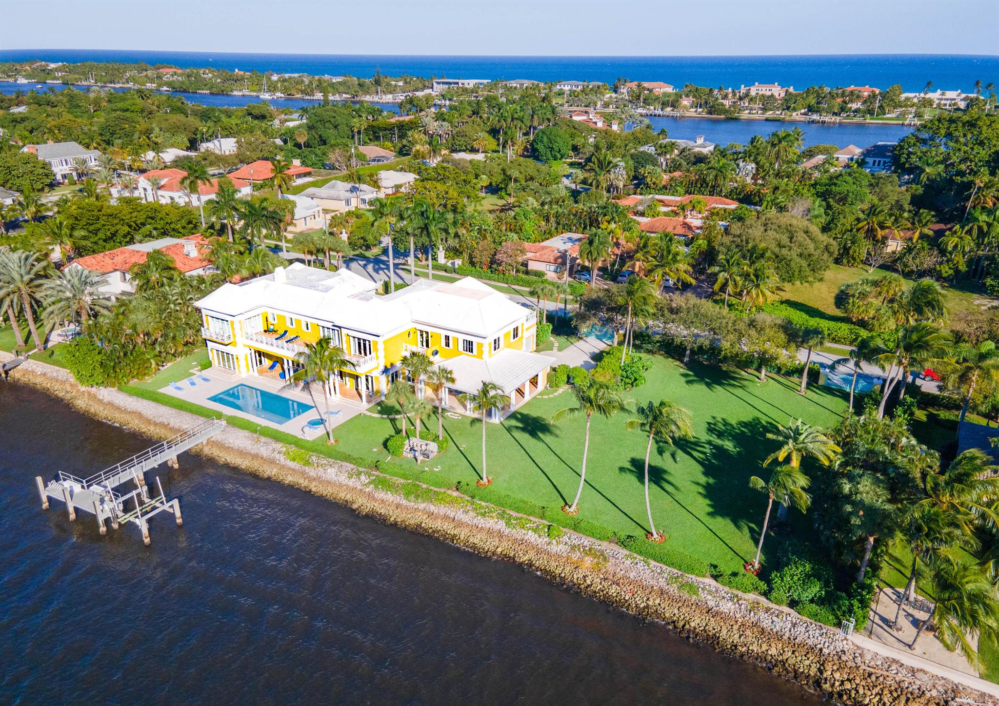 Grand Waterfront Estate with nearly 300 feet on the wide intracoastal and a short drive south of palm beach, this absolutely stunning gated estate boasts 12.828 sq ft with 7 bed rooms and 8.5 baths. This home features 12 ft ceilings thought out, a large upstairs master suit serviced by private elevator, formal living room and dinning rooms, den, media, study and sensational family room that opens to a large covered Loggia with summer kitchen, impact resistant French style doors and oversized windows create a bright and airy interior. Oversized pool and spa are finished in glass mosaic tile, the doc can accommodate a 140 ft yacht. This home is in move in condition with large laundry room with 2 commercial size washer and dryers plus a huge 4 car garage are but a few of the other highlights