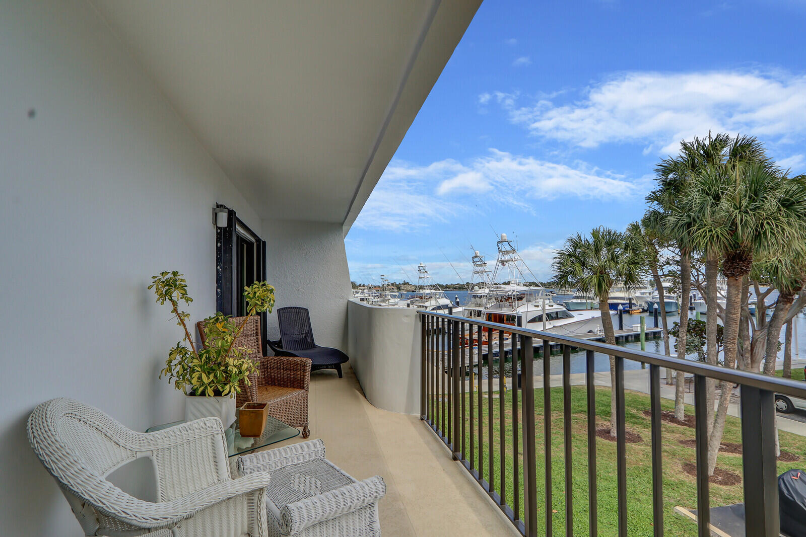 Marina and Intracoastal Views from this 2 bedroom split plan with an exceptional floor plan.  Wide Waterfront Balcony.  Steps to the marina and 2-mile waterfront walking path. Modern Kitchen Cabinets, Updated Primary Walk-in Shower. Lots of closet space.  This unit currently does not have a washer & dryer, but the building allows you to put them in.  Garage parking spot. Extra wide great room and kitchen can be opened up to the main living space.  New impact sliders in Living Room and both bedrooms. Walk to Belle's Marina Restaurant.  Steps to the heated pool, community rooms and tennis court.