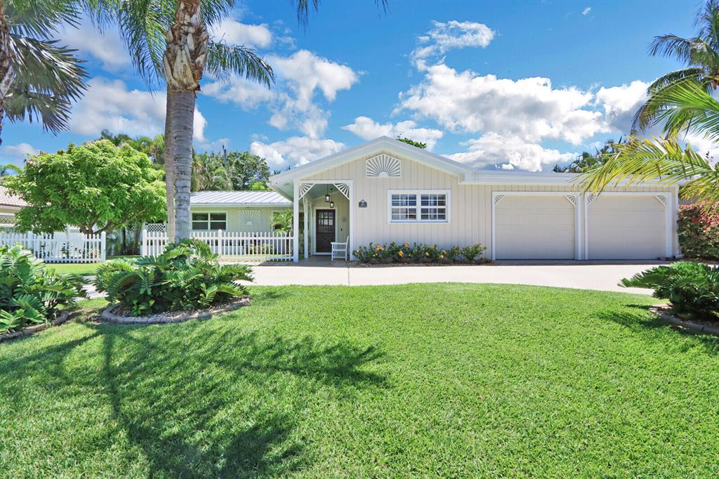 This updated coastal style Juno Beach home just a short walk to the Atlantic Ocean and Pelican lake has everything you need to start living the South Florida lifestyle today. This home is perfect for entertaining featuring an open concept floor plan a large custom kitchen with white cabinets, granite countertops and top-of-the-line Kitchenaid stainless steel appliances all centered around a large island with seating for 5. A wine bar and mini-fridge can also be found off the side of kitchen. The private gas heated pool (2013), oversized spa and outdoor hot shower with cabana bath is a tropical oasis that can be used any time of the year. Real red oak hardwood floors through out the main living area and engineered oak wood floors in all bedrooms can be found in the home. The wood burning fireplace with stack stone is the perfect place to gather around during the holidays. This home has two primary bedrooms with en-suite bathrooms and two guest bedrooms. One of the primary bedrooms features a recent addition spa like bathroom with extra deep soaking tub with waterfall faucet and built-in chrome towel warmer with a 10-bar rack.Tropical Fruit trees can also be found on the property- Avocado, Mango, Banana, Coconut This home truly has it all scheduled your showing today to own a piece of paradise. Open house on Aug 22nd from 1-3pm.

