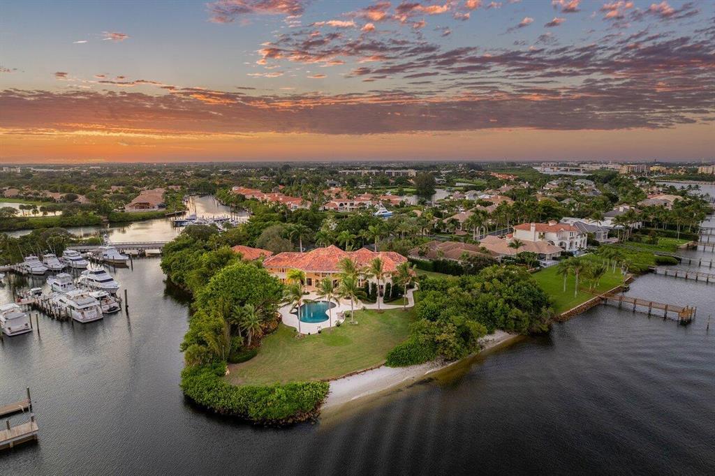 Welcome to 3208 Pilots Point Circle, one of the most exquisite, private, waterfront estates in all of Jupiter. This direct intracoastal estate is situated on almost 1.5 acres of land, with an astonishing 605' of water-frontage, and a private beach. Custom built with designer finishes throughout, The main house offers 6 bedrooms, 5 full baths, 2 half baths, an office, library, private theater, formal dining room, chef's kitchen, formal living room, family room, and more.The detached Guest House, built in 2015, has a fitness center complimented with a tanning room and spa on the first level. The private upstairs offers a stunning guest suite with hardwood floors, living room, open kitchen, and luxurious bedroom. Please click on the supplement link for a full write up of this property