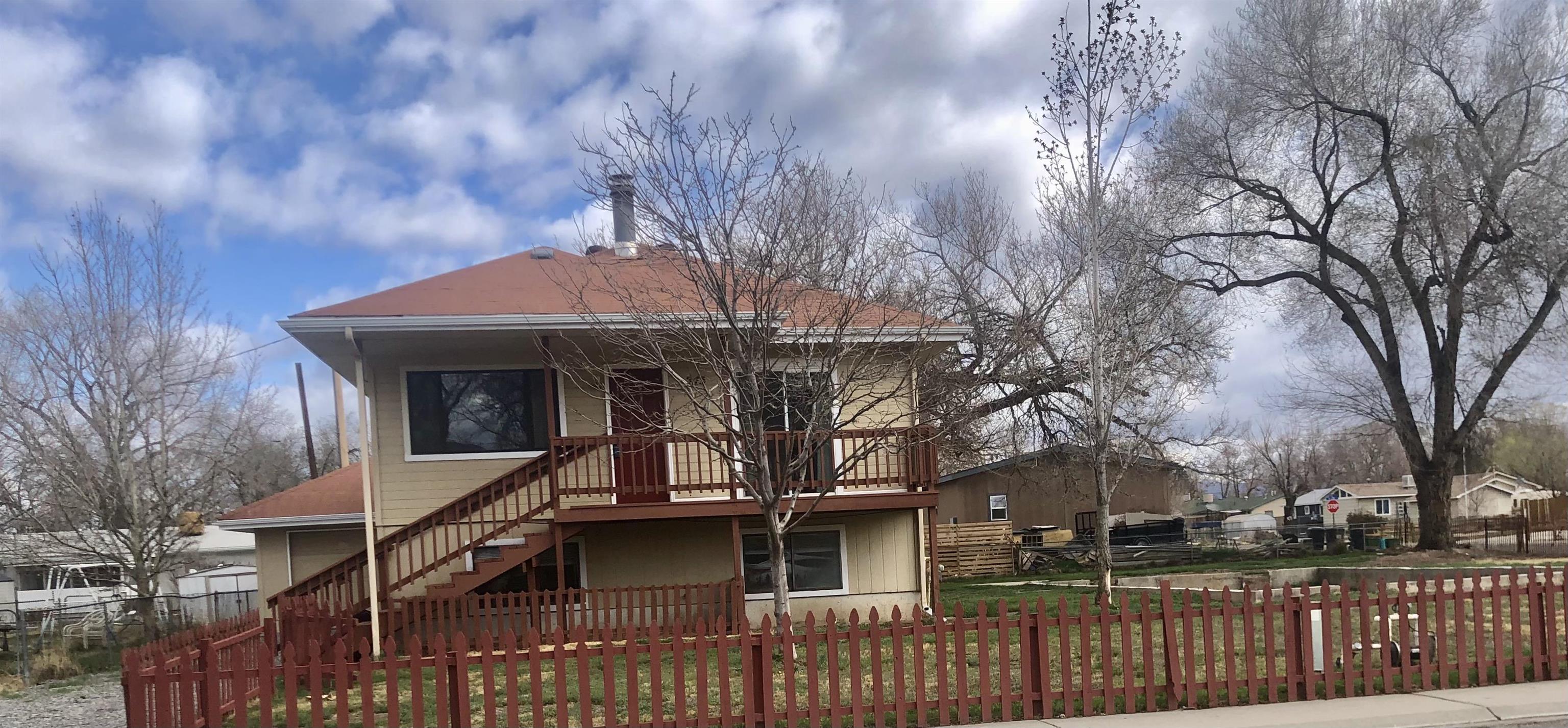 New carpet and paint in this unique home in the heart of Fruita.  Home features 3 living areas or possible bedroom options. All of this is nestled on a large corner lot with lots of possibilities. Foundation in place for prospective shop, mother-in-law set up, or VRBO.