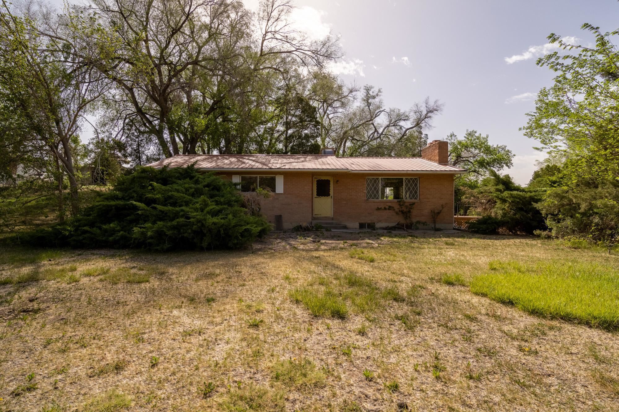 They don't build them like this anymore.  This brick, raised Ranch harkens back to the 1960's with a full basement is waiting for you.  You might appreciate the real hardwood floors in the upstairs bedrooms. Or, you might appreciate the flagstone patio. Home is situated to have amazing views of the Monument.  Large, approximately 3/4 acre lot boasts of mature trees, with 1 Share of Grand Valley Irrigation Water. Basement bedrooms are non-conforming due to windows.  However, the basement is a walk-out basement.
