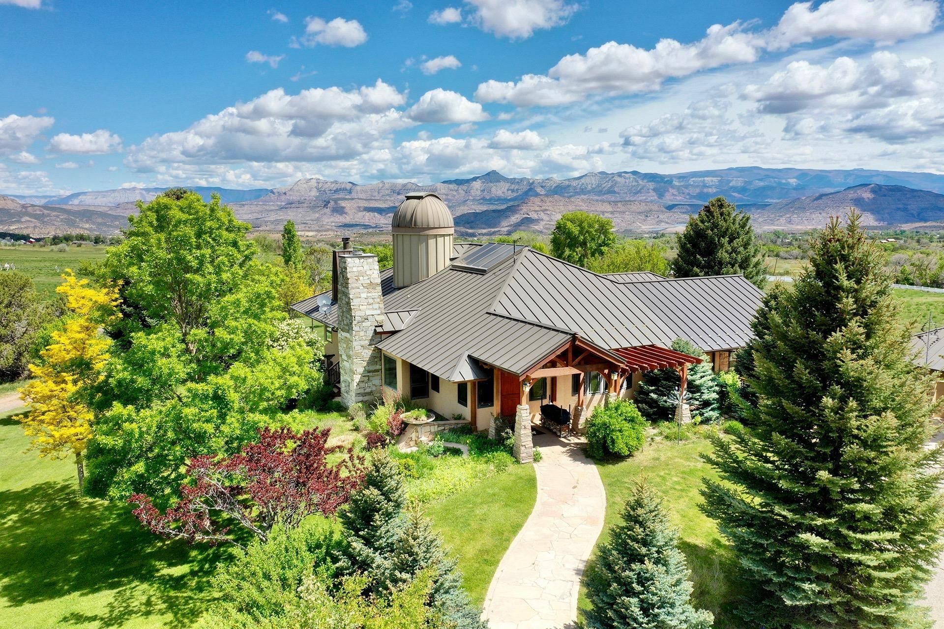 This gorgeous 18 acre estate has everything you have been dreaming of. Relax in your wonderfully appointed 5460 sqft four bedroom residence with stunning 360 degree views of the Plateau Valley, the painted mountains of the Roan Plateau, the ski slopes at Powderhorn Mountain Resort and the Grand Mesa. View the stars from your own observatory and entertain your friends in the stunning gardens or multiple outdoor seating areas. The separate, charming, two bedroom guest cottage is perfect for your guests, a care taker or rent it out as a vacation rental. The property has ample water rights for irrigating the mature gardens and two hay fields. Your horses will be right at home in their grazing pasture equipped with a newer shed to protect them from the elements. Tate Creek runs through the property and attracts ample wildlife for your viewing pleasure. The detached four car garage can accommodate your vehicles and the additional storage sheds are perfect for your ATVs and other outdoor toys. There is plenty of room for your RV on the property and a place to plug in if needed. This is truly a beautiful and unique property, that checks all the boxes…and then some! Listing Broker is related to the Seller.