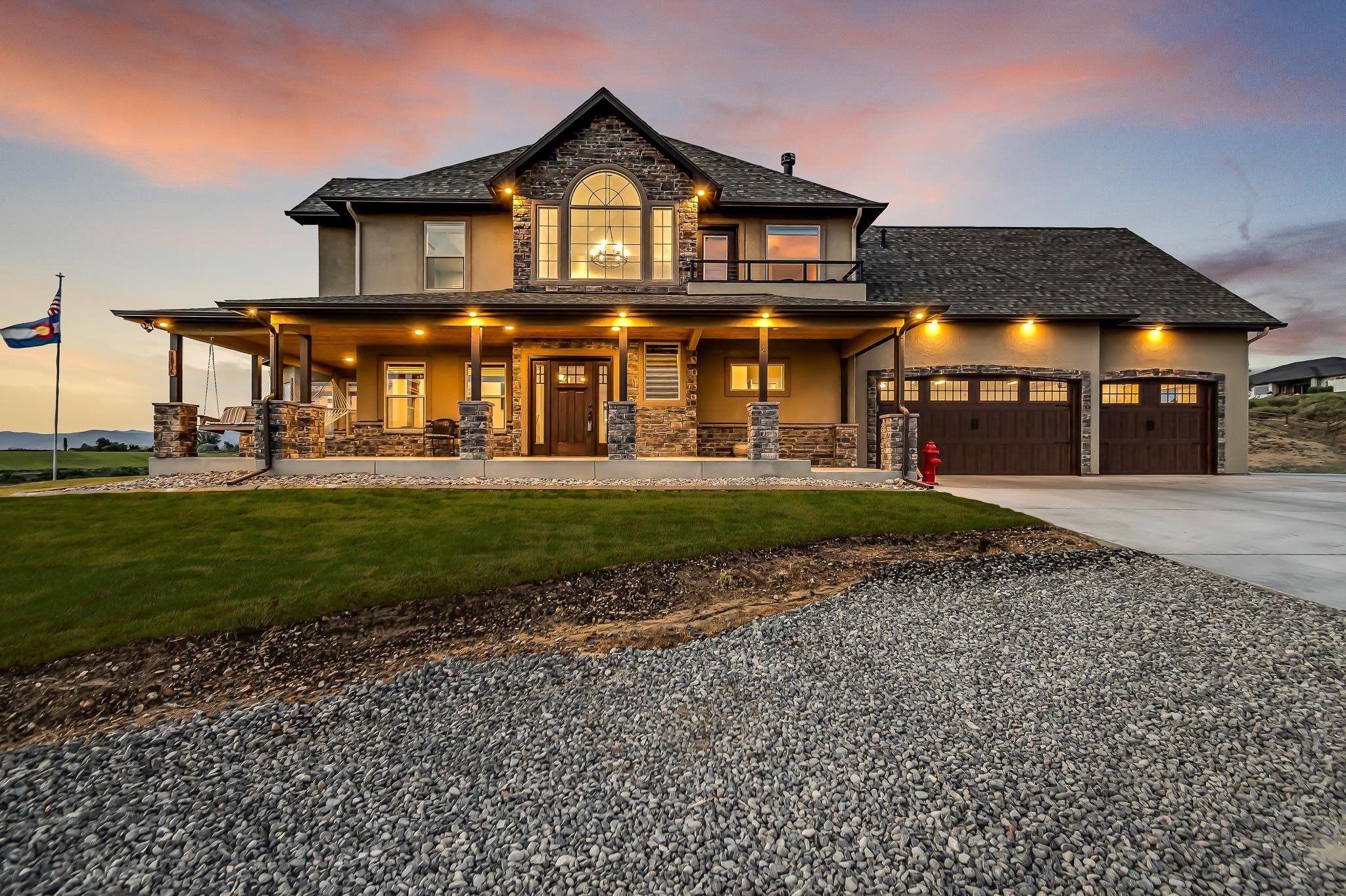 Country living & panoramic views are just the foundation to this sensational Elk Ridge custom-built home! This estate exudes pride of ownership with its pristine craftsmanship, high-end finishes, and professional landscaping. It boasts privacy without isolation, as you take in the 360 degree views of the Grand Valley on 5.94 acres bordering BLM land. The interior of the home invites you into a stunning foyer with beautiful engineered hardwood flooring. Accompanied by two large living spaces, formal dining area, kitchen with granite countertops & stainless steel appliances with a plethora of natural lighting and stunning views. Upstairs you will find a gorgeous master suite with a private balcony to enjoy your morning coffee, along with two extensive bedrooms adjoined by a Jack-and-Jill bath, and a 3rd bedroom and/or office down the hall from the rec room, equipped with a kitchenette. This bonus space is ideal for entertaining; alternatively, it could easily be converted into an additional master suite or mother-in-law suite. Finish off the day, relaxing in the hammocks on the wrap around porch taking in those unobstructed, picturesque Bookcliff sunsets. No detail has gone missed in this estate, as it is the only custom-built home you will find in Mesa County with a firepole! It is the definition of luxury living in the countryside!