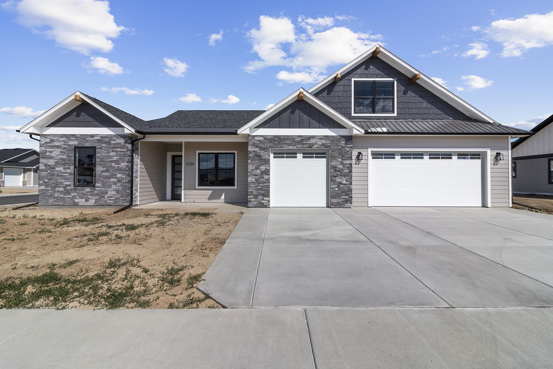 NEW CONSTRUCTION by TreyTyn Homes, LLC in northwest Grand Junction's country-chic subdivision, Silver Spur! This open & flowing ranch style floor plan also features an upstairs bonus room, complete with full bathroom, for added functional living space! The covered front door leads you into the grand entry that allows for convenient access to the front two bedrooms, which also share a jack-and-jill bathroom. Additional office space (or additional bedroom, as it has spacious closet) sits behind attractive and modern barn sliding doors. The open living room features cathedral ceilings and a cozy fireplace for added ambiance. The chef's kitchen features a large island, premium granite countertops, upgraded cabinets, unique tile backsplash, upgraded stainless appliances and durable luxury vinyl plank flooring! The split bedroom floor plan allows for a private and spacious master suite (which sits adjacent to the laundry area for added convenience!), that's complete with oversized walk-in closet  and en-suite bathroom with dual vanities, custom walk-in shower and private lavatory. Covered back patio is the perfect space for relaxation and enjoyment of your spacious backyard area. RV parking space on east side of the property!