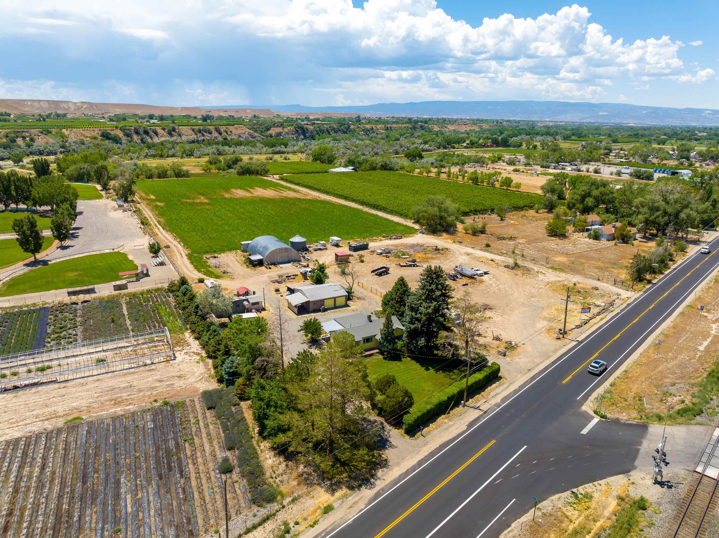 11.54 acres, 2 parcels with multiple outbuildings and TONS of potential!  This property has great frontage off of Highway 6 in Palisade and sits just outside Palisade city limits. With breathtaking 360 degree views, this property has many possibilities.  The existing home has been updated over the years including: roof, furnace, carpeting, kitchen, plumbing and electric.  Book your private showing today!
