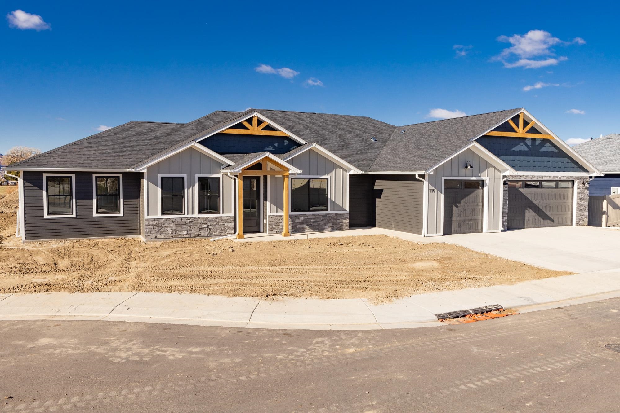 NEW CONSTRUCTION by TreyTyn Homes in Silver Spur subdivision; Northwest Grand Junction's newest country-chic subdivision that boasts incredible views, coveted location in the highly competitive Appleton school district, and near area shopping, entertainment and events! This unique floor plan has an attached ADU unit (separated from the main house) with it's own private entrance -- perfect for a mother-in-law setup or income-producing long term rental! Main house features 4 bedrooms over a flowing and functional floor plan! As you walk in the main entrance, you're greeted by a conveniently located office/bedroom space and all bedrooms conveniently located on the south side of the home. Guest bedrooms share a full bathroom, upgraded with premium cabinetry and custom tile. Primary bedroom offers a LARGE walk-in closet for plenty of storage and en-suite bath with dual vanities, oversized walk-in shower with bench seating and enclosed lavatory. Open living room and kitchen is the perfect space for entertaining guests, especially with the added ambiance of the living room electric fireplace that features glass rocks and color-changing flames! Large island and custom pendant lighting add to the richness of the space! Custom cabinetry, tile backsplash and upgraded counter tops make this kitchen space chef's quality! Eat-in dining space with access to the large covered patio. Additional dwelling unit sits to the west of the oversized 3-car garage and features full kitchen, large living/dining room area and one bedroom with full bathroom! Property has plenty of RV parking on the south side of the home and offers incredible east-facing Grand Valley views!