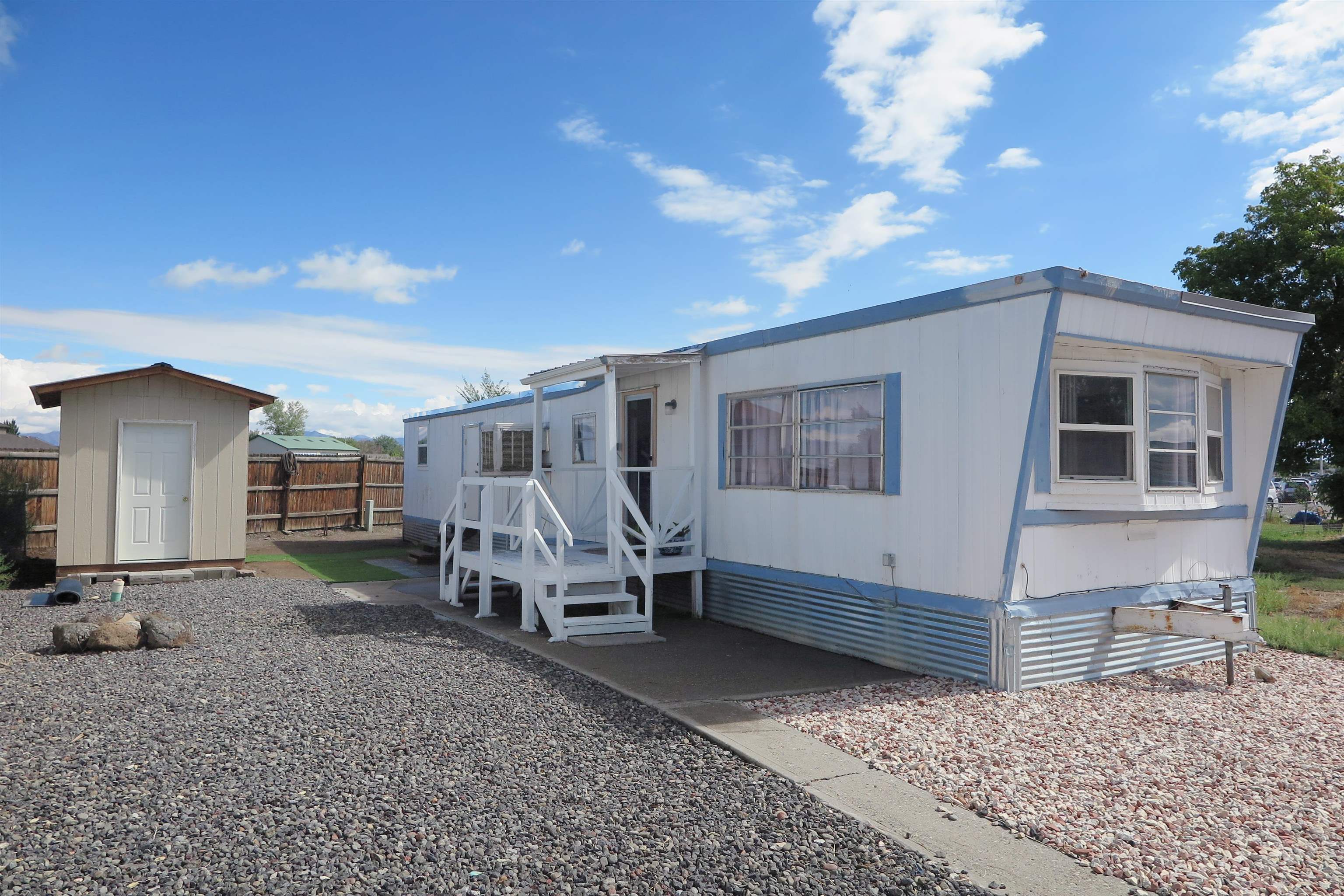 Cute and remodeled mobile home in convenient Fruita location. Lots of recent updates include re-sealing of entire roof, fresh paint and flooring, almost new appliances, and lighting. The 2nd bedroom was converted in to an office/laundry room and there is also a large storage shed. The kitchen boasts new cabinets and countertop plus all appliances are included with the sale.The evaporative cooler was just serviced and the furnace is only a few years old. Some windows in the home were also updated.